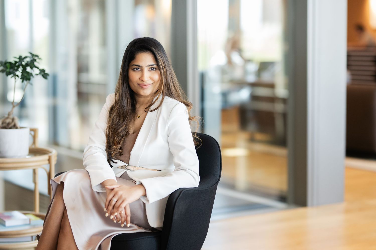 Professional photos showing person in white blazer against window-lit office background.