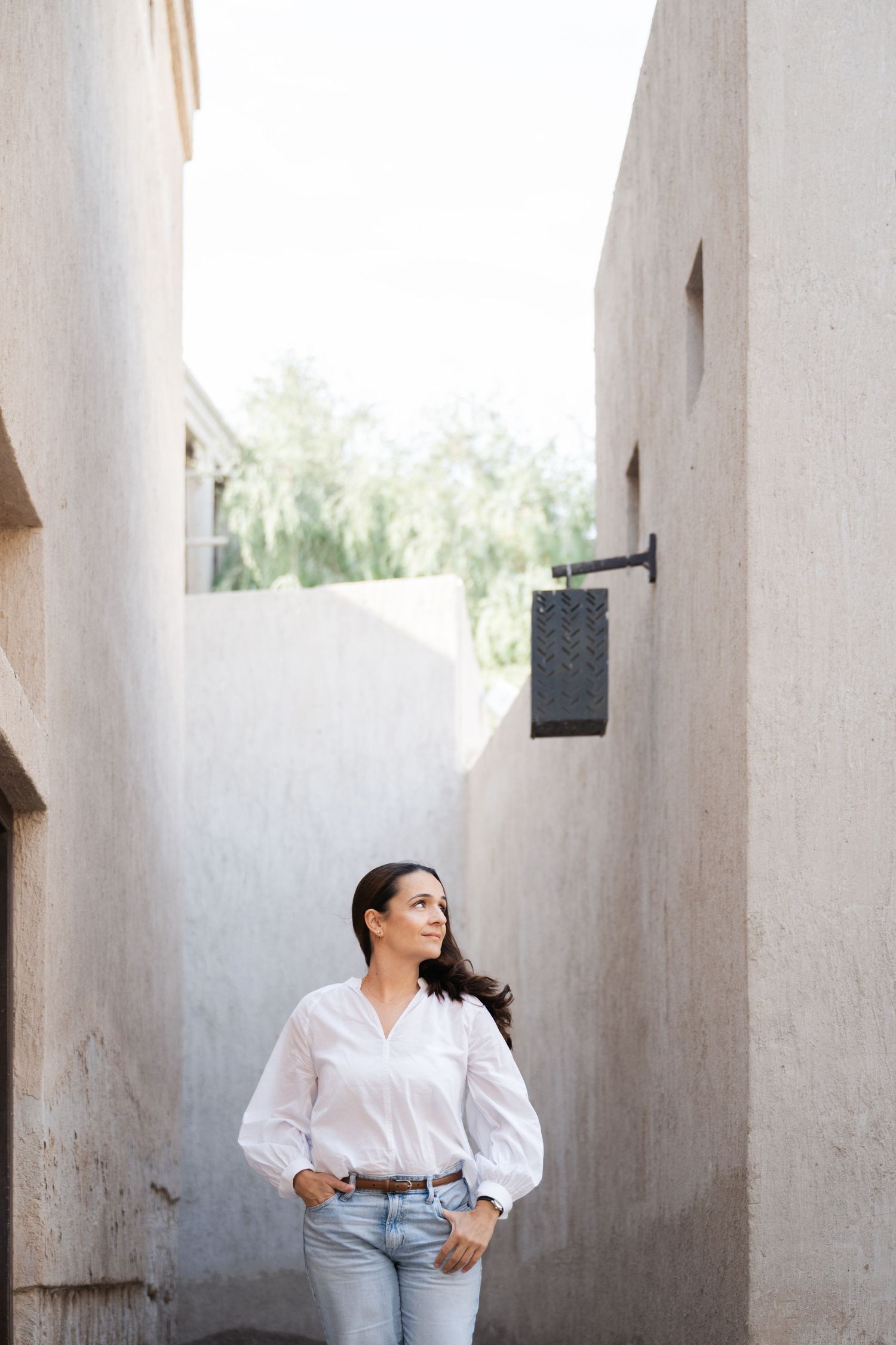 Architectural portrait session with white columns and clean lines.