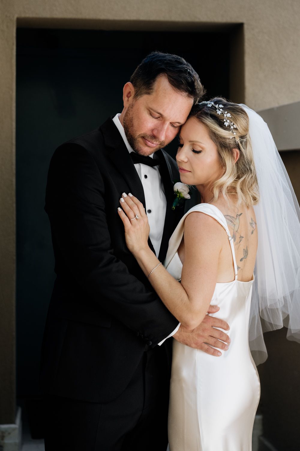 Minimalistic wedding couple portrait hugging