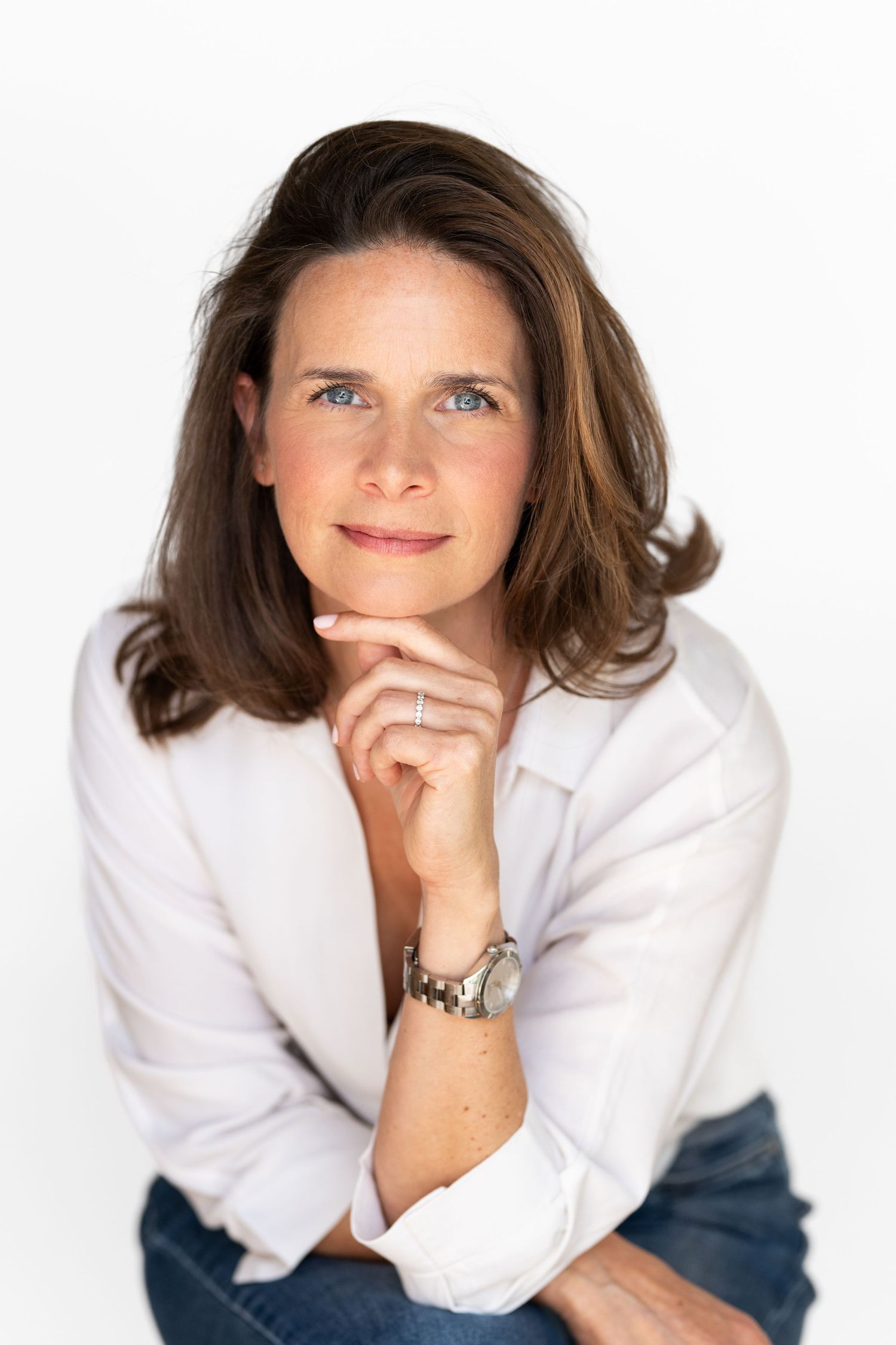 Professional headshots in white blazer against clean white background.