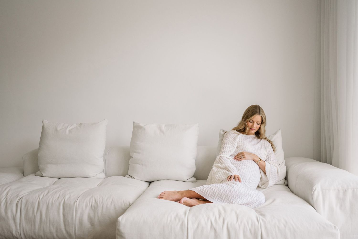 Artistic photo series showing a person in white bedding creating dreamy movement and ethereal poses on a bed.