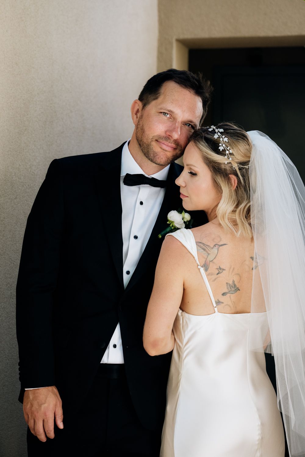 Minimalistic wedding couple portrait bride with back tattoo