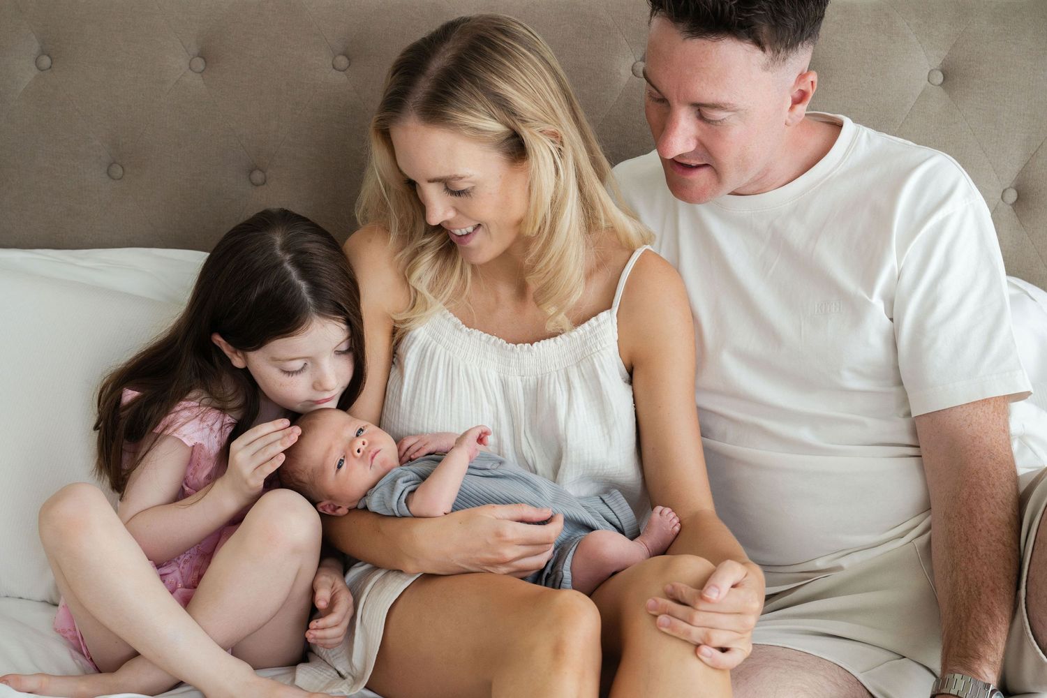 Family moments captured showing girl and baby snuggling together.