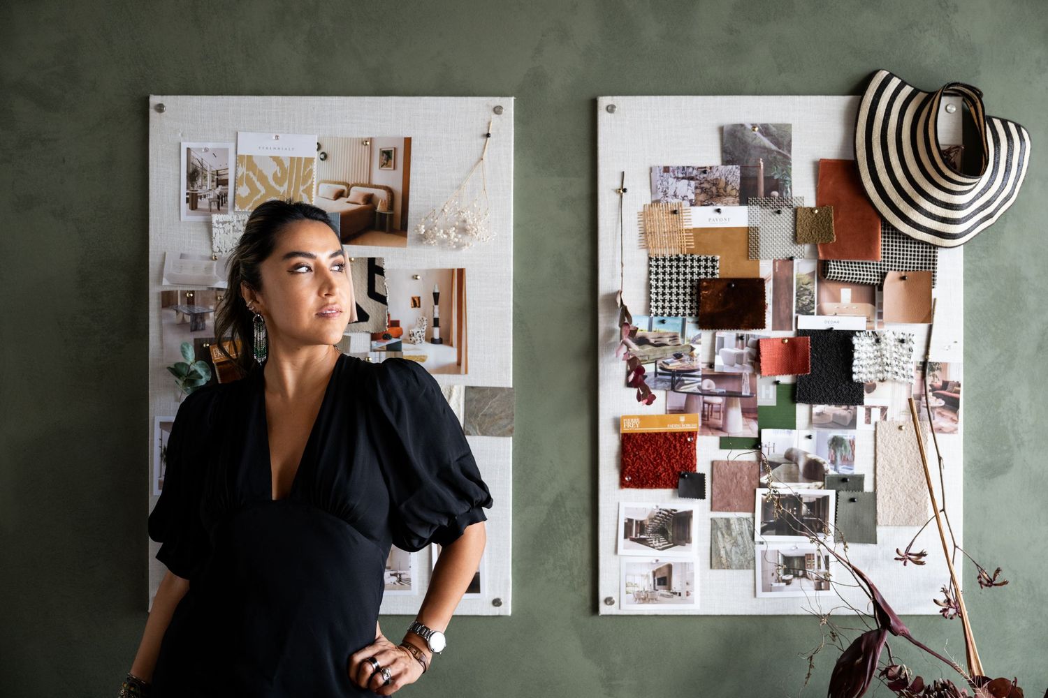 Design mood board with various images and patterns displayed on a green wall.
