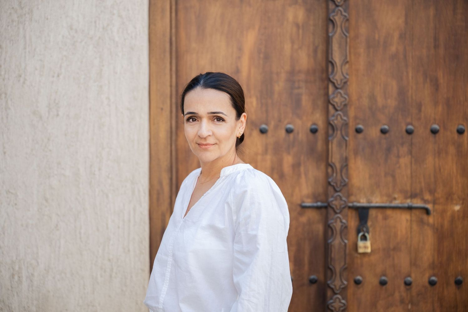 Professional headshots against rustic wooden door background.