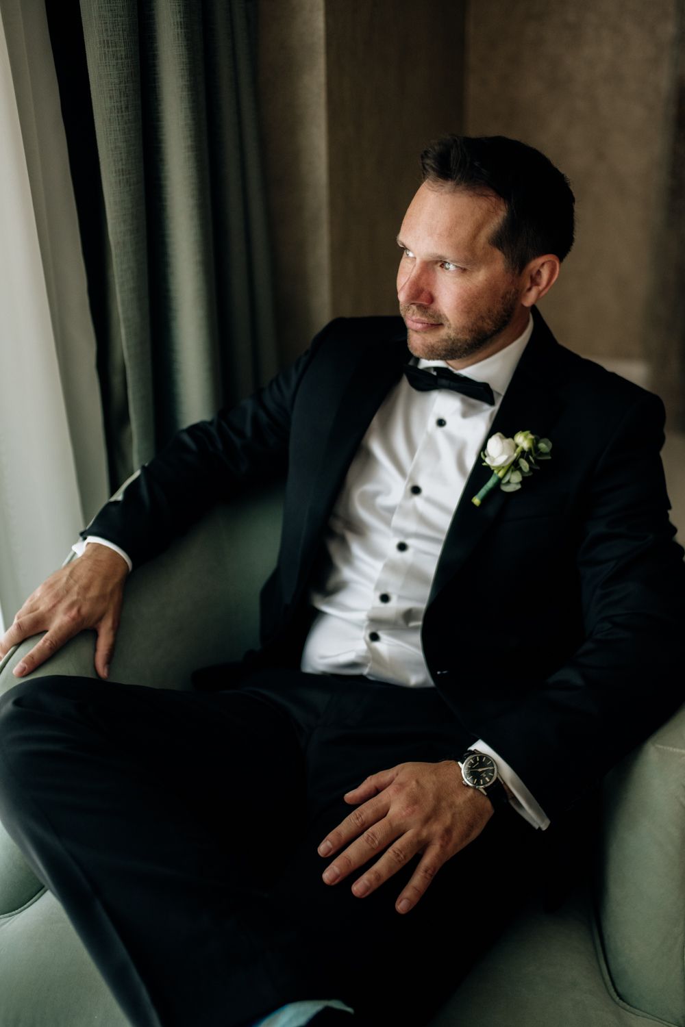 Groom sitting in armchair