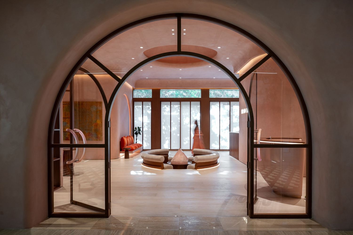 Elegant arched hallway with symmetrical design and natural light flowing through multiple doorways.