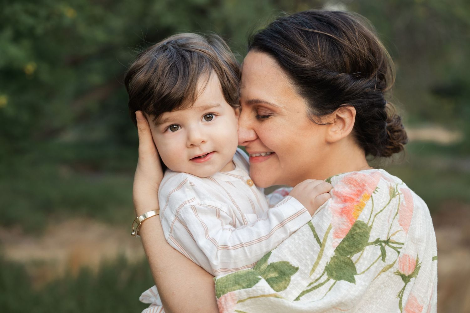 Sweet outdoor portrait series with soft natural lighting and greenery.