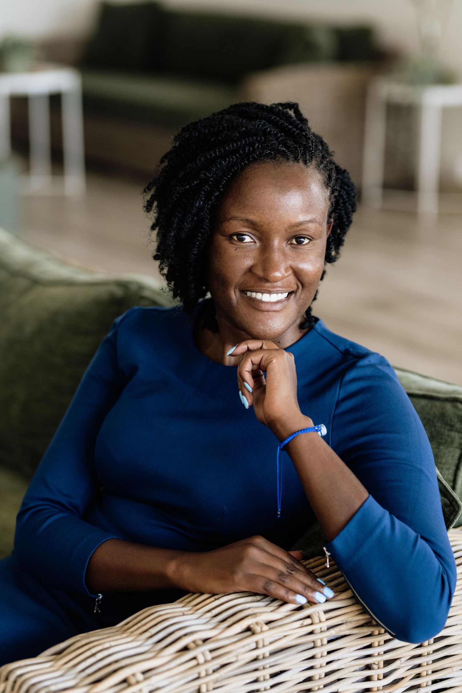 Professional headshots showing relaxed poses in a navy blue outfit.