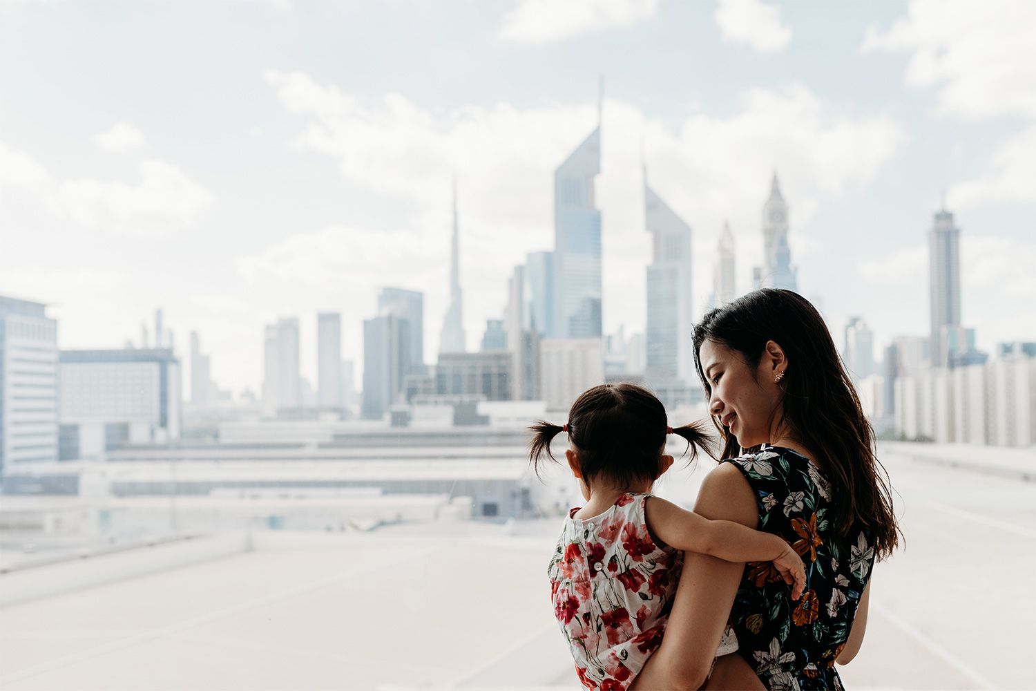 Mother and daughter natural moment captured against Dubai skyline