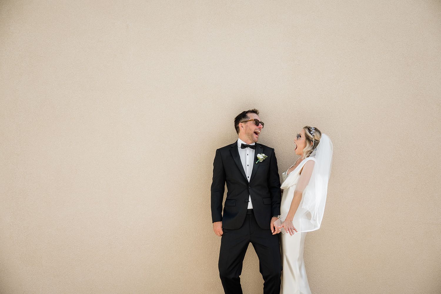 Artistic series of wedding couple portraits against a neutral wall.