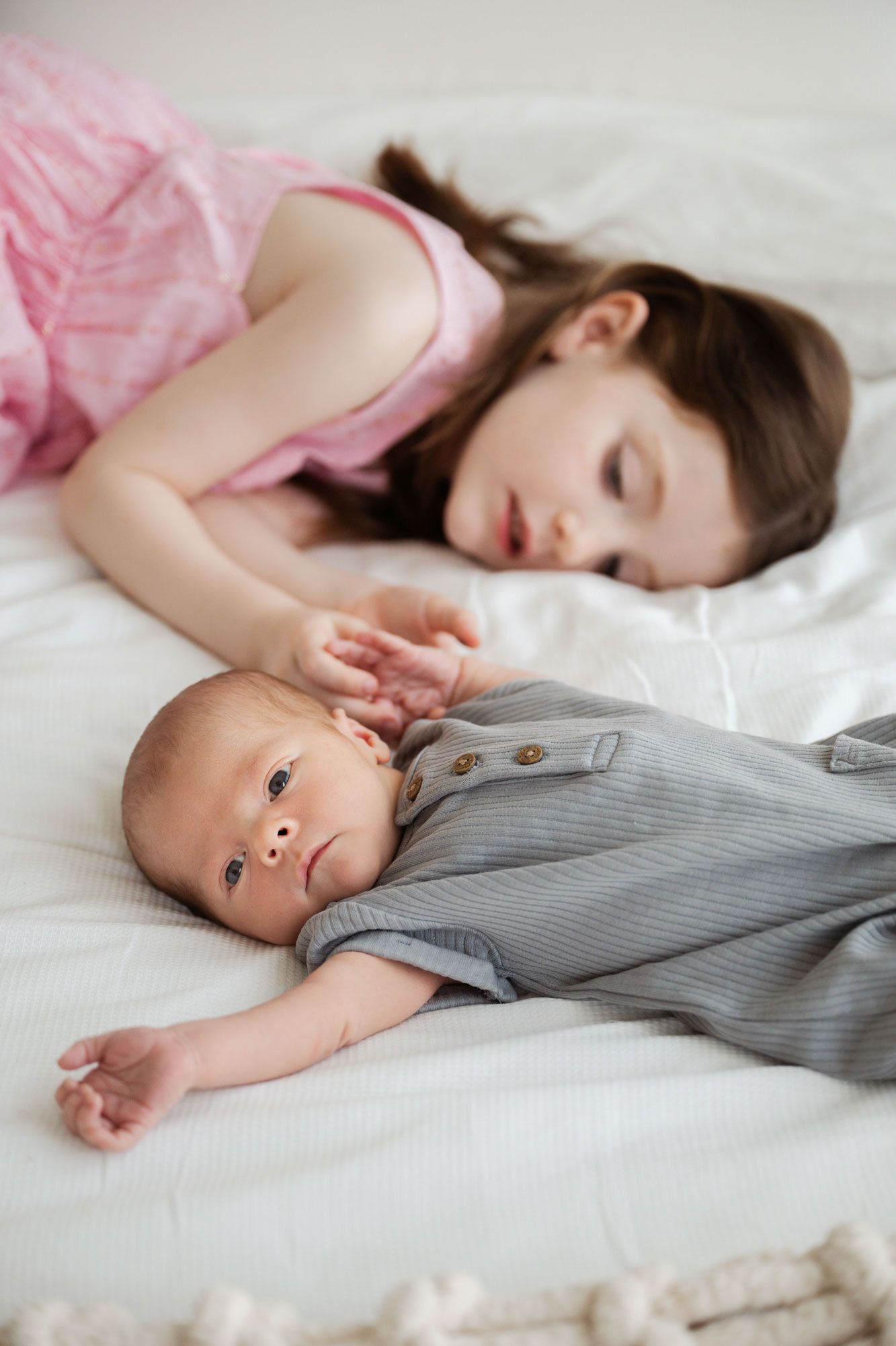 Newborn baby and sister lifestyle photo at home
