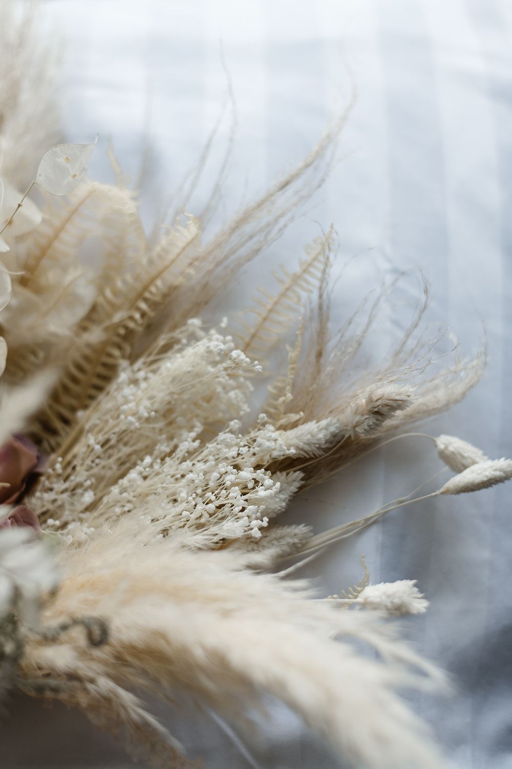 Close-up of dried pampas grass and neutral-toned dried flowers.
