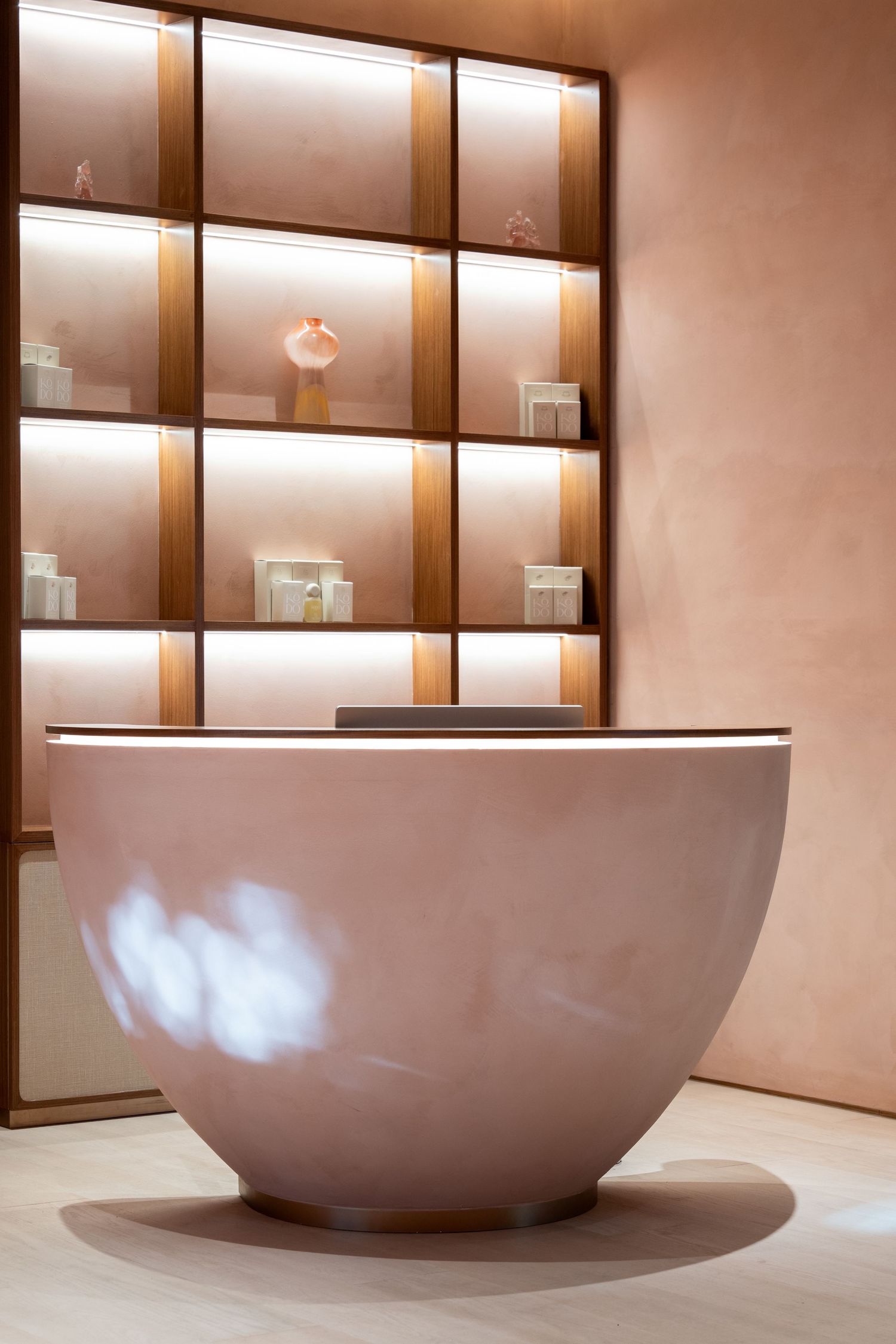 Luxurious spa-like space featuring illuminated shelving and a large freestanding white bowl basin.
