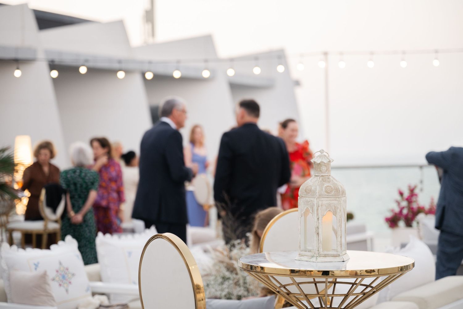 Elegant event space with gold accents and modern furniture setup.