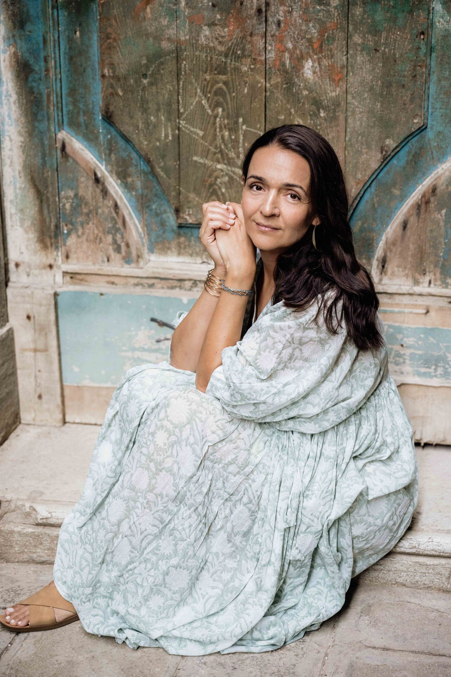 Fashion portrait against vintage Venetian architecture with distressed turquoise door.