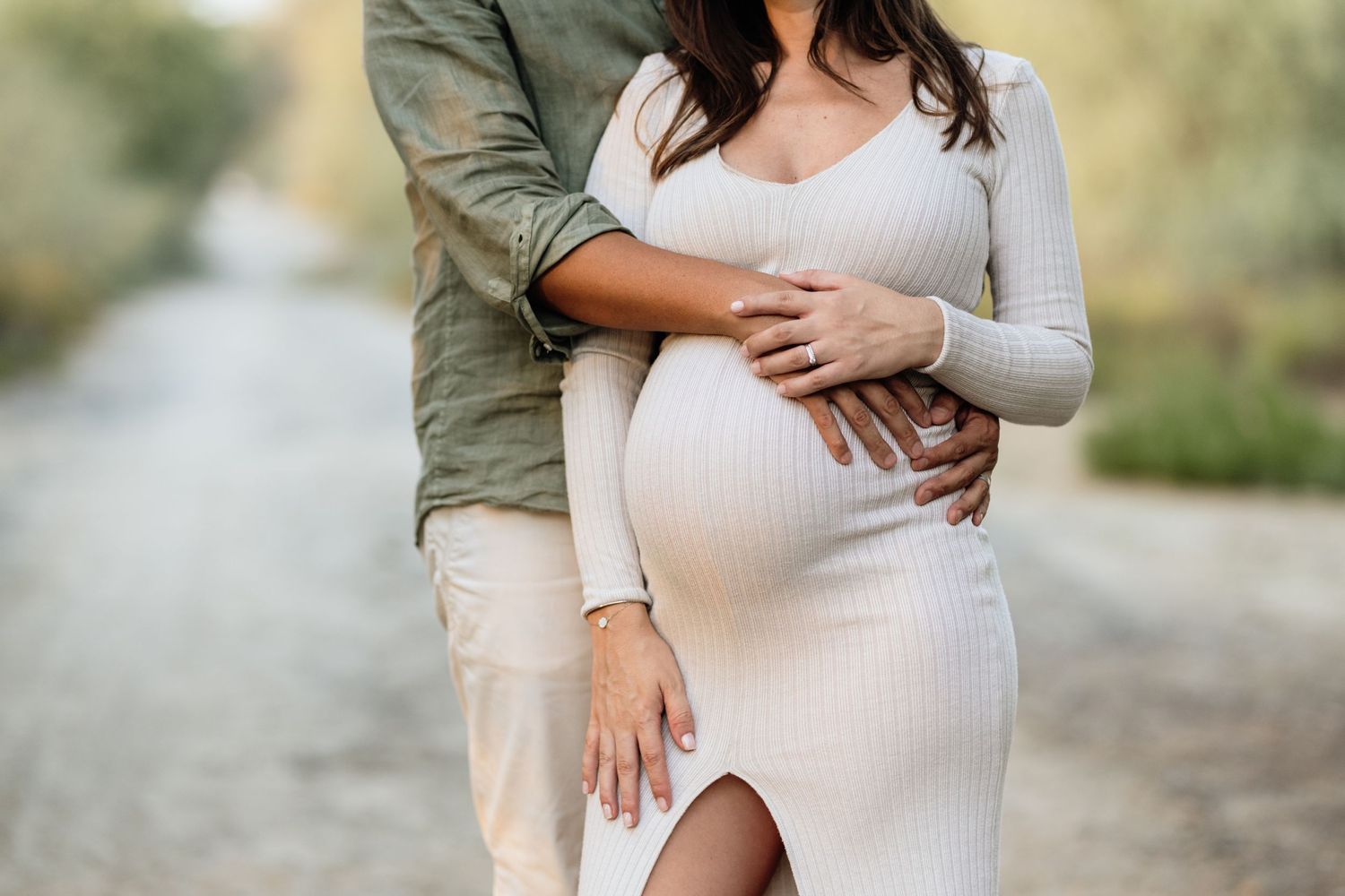 Intimate maternity photos taken outdoors in natural lighting.