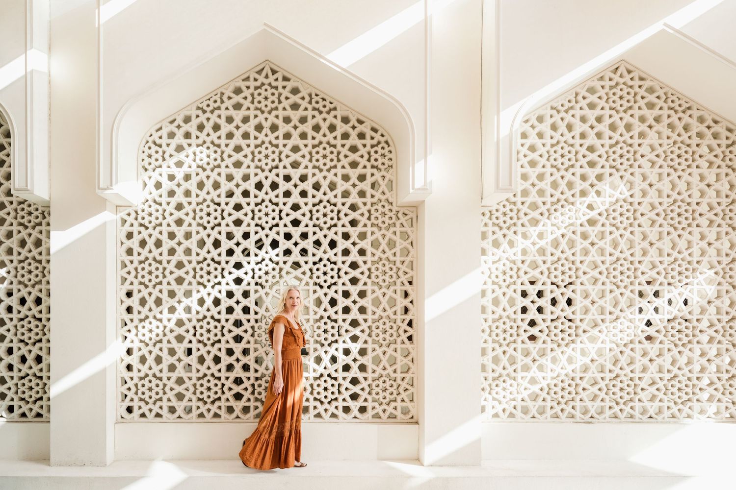 Decorative Islamic architecture with intricate geometric patterns and natural lighting.