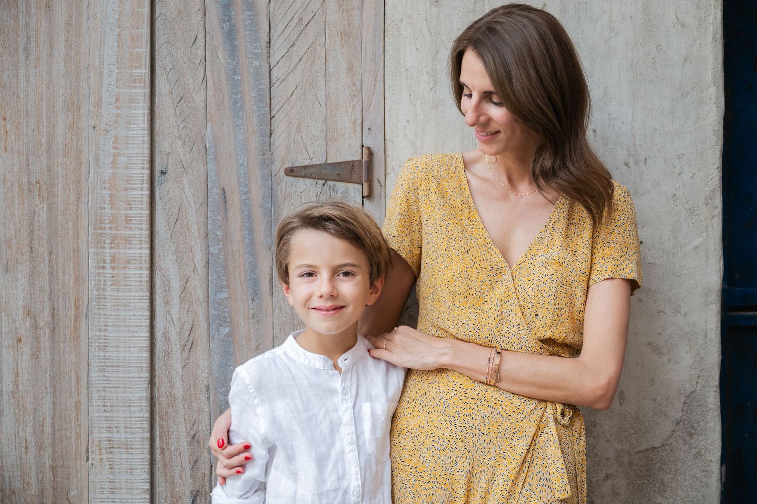 Family portrait series against rustic wooden wall background.