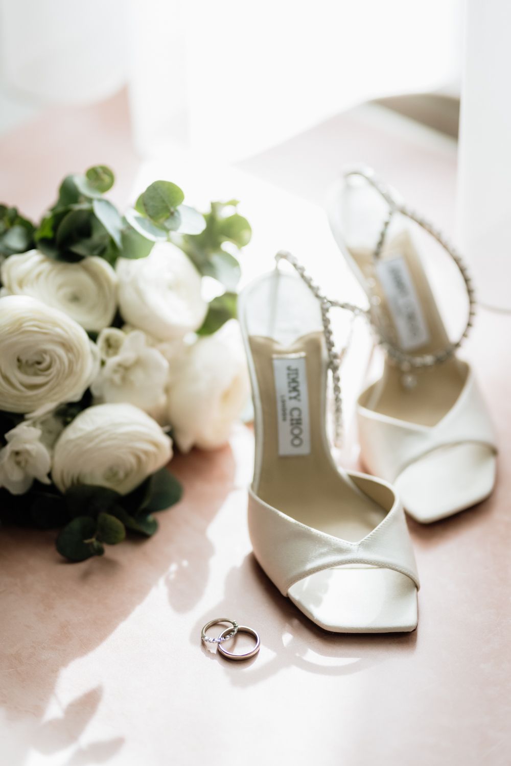 Wedding details shoes rings and bouquet