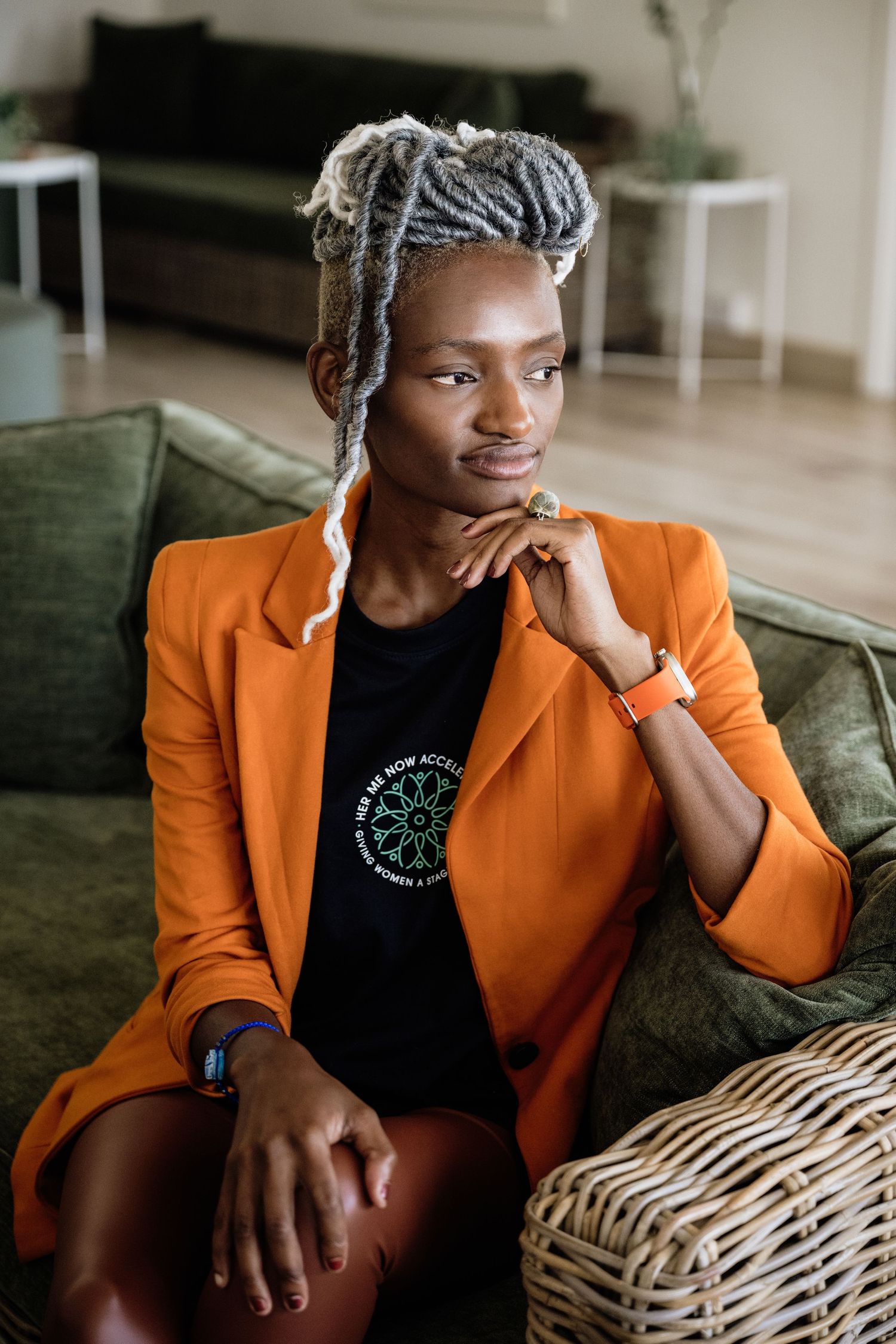 Professional portraits featuring bright orange blazer and casual sitting poses.
