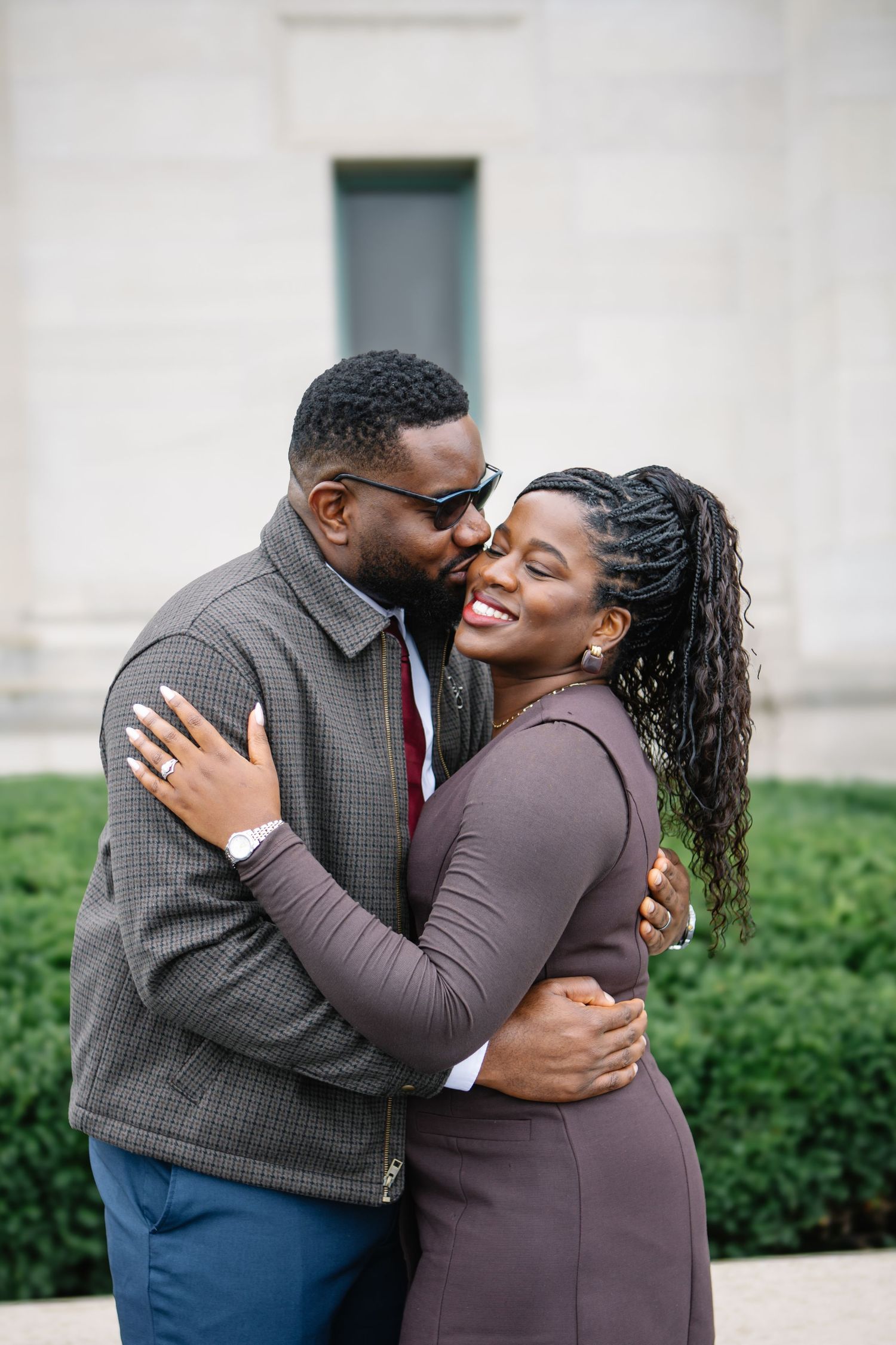 Joyful couple embracing and laughing together outdoors.