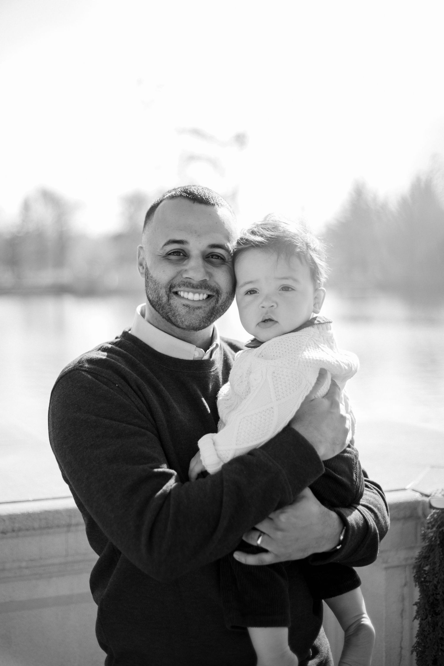 Black and white portraits showing tender moments between parent and child outdoors.