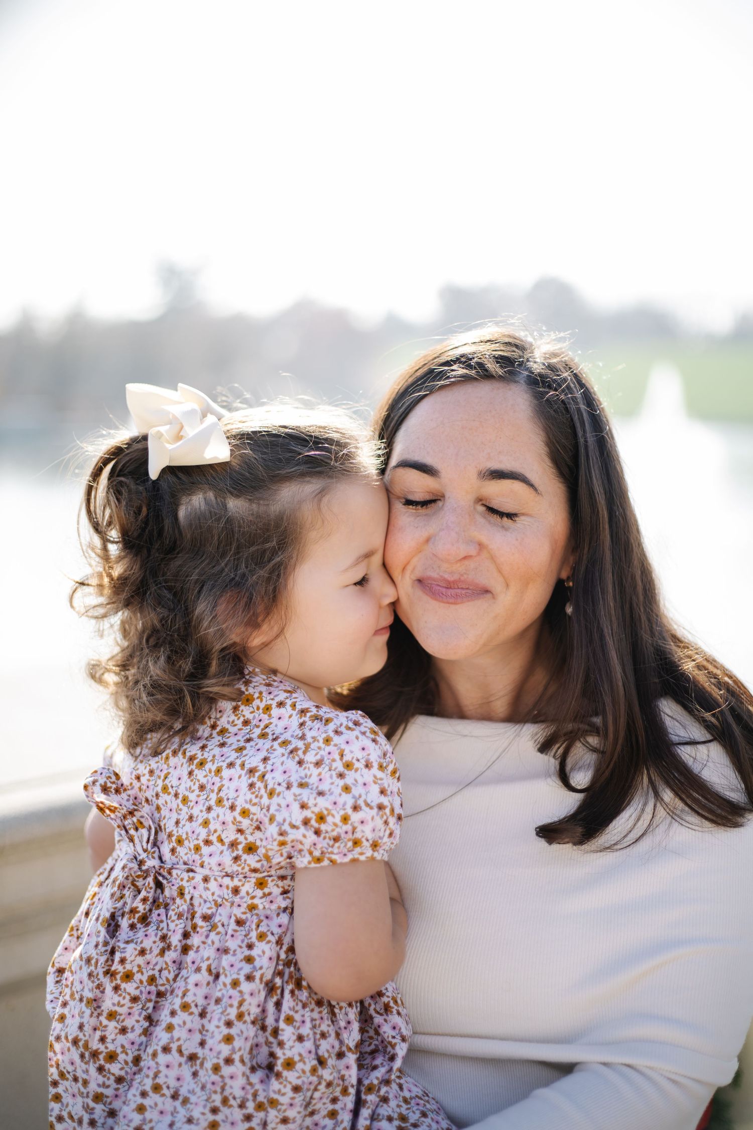 A tender moment between parent and child as they share loving kisses and embraces in a series of candid photos.