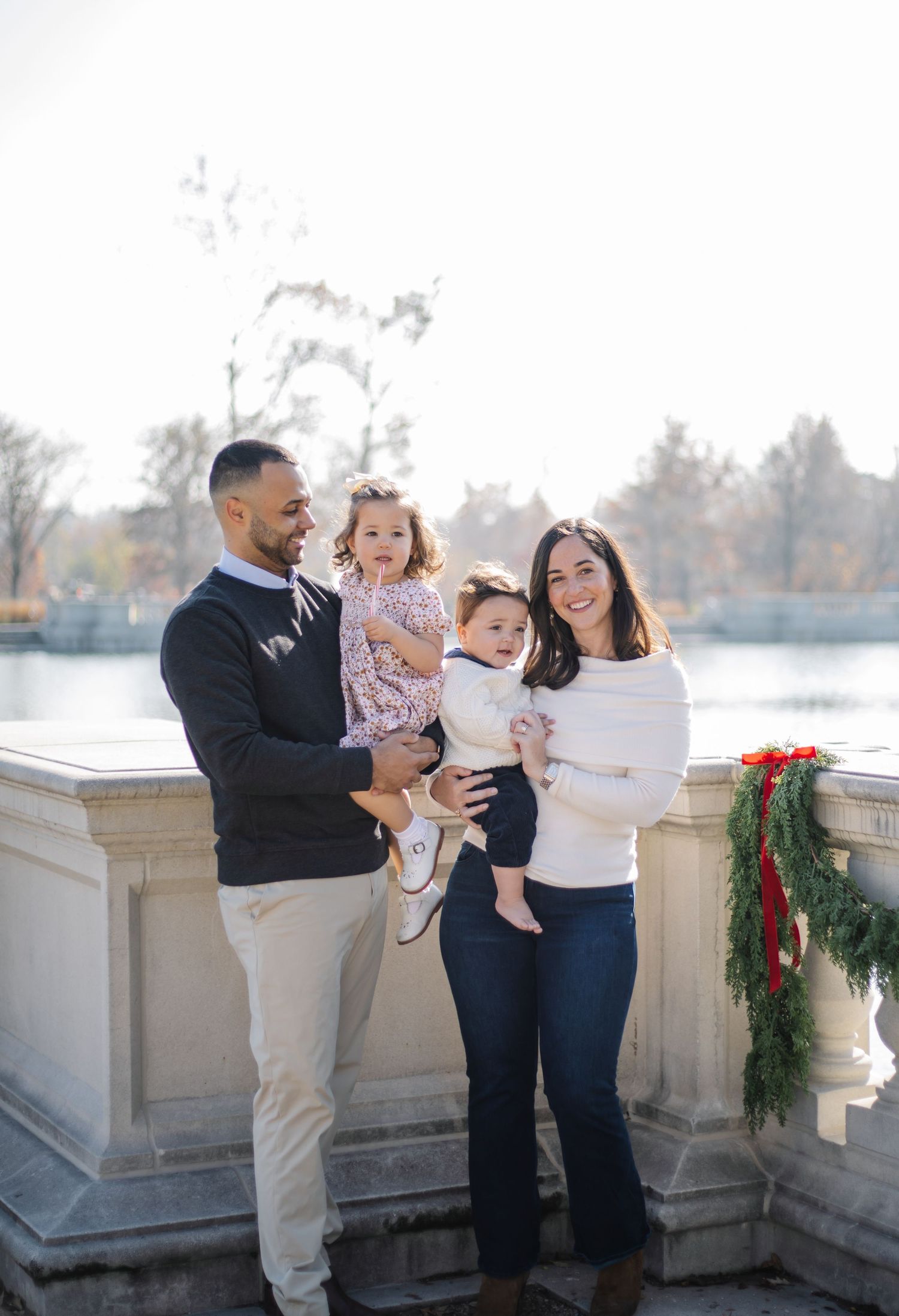A family shares intimate moments together during an outdoor photo session.
