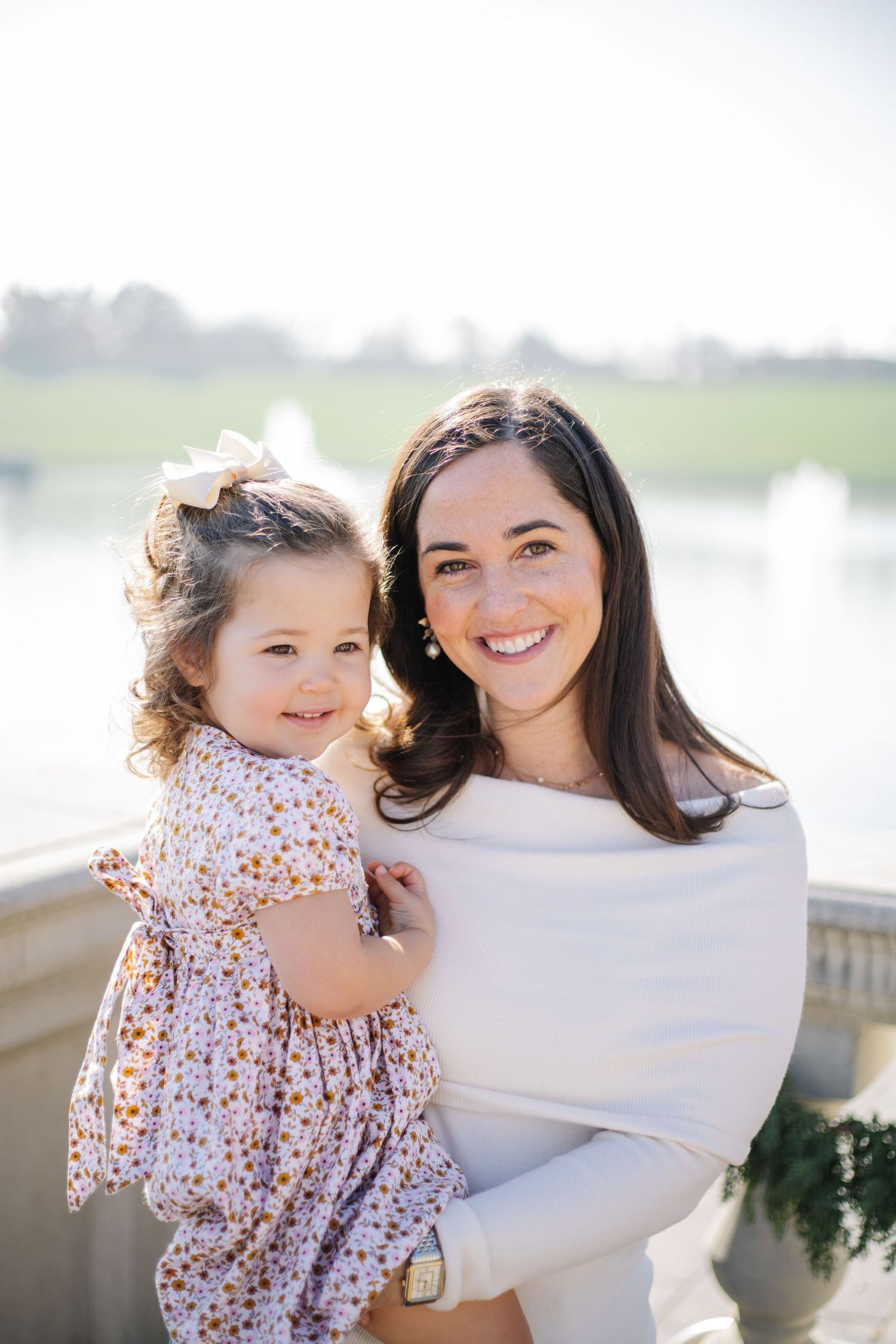 A sweet outdoor portrait session captures tender moments between a parent and child.
