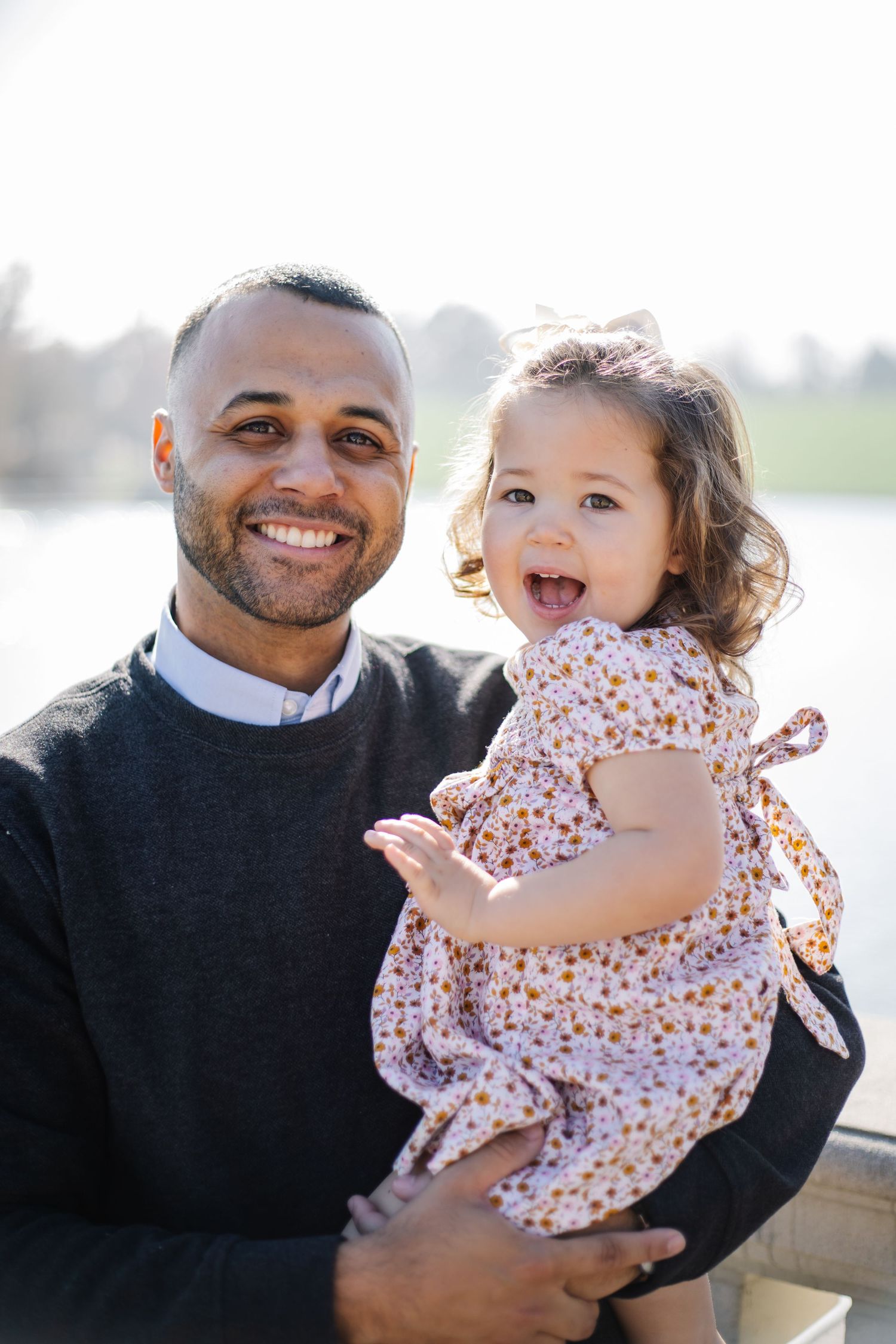 Candid family photos showing playful interactions and laughter on a bright day outdoors.