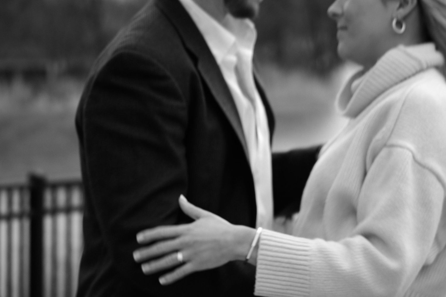 A tender black and white wedding moment captured outdoors.