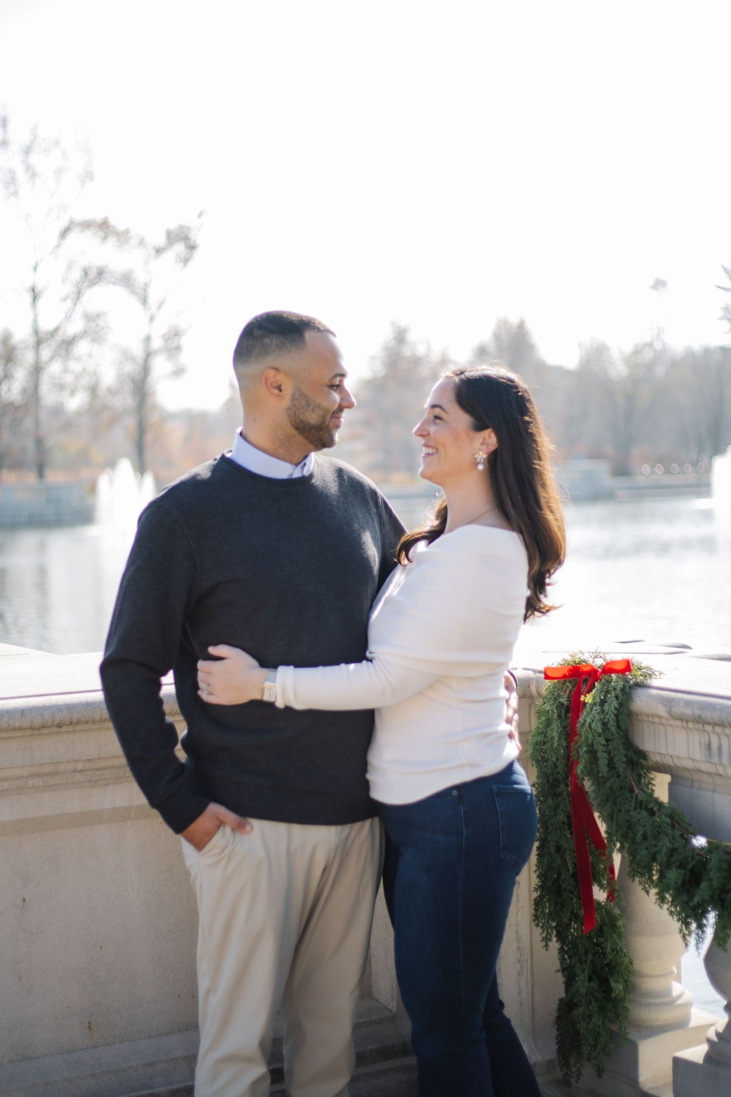 Candid family interactions photographed on a stone balcony with festive decorations.