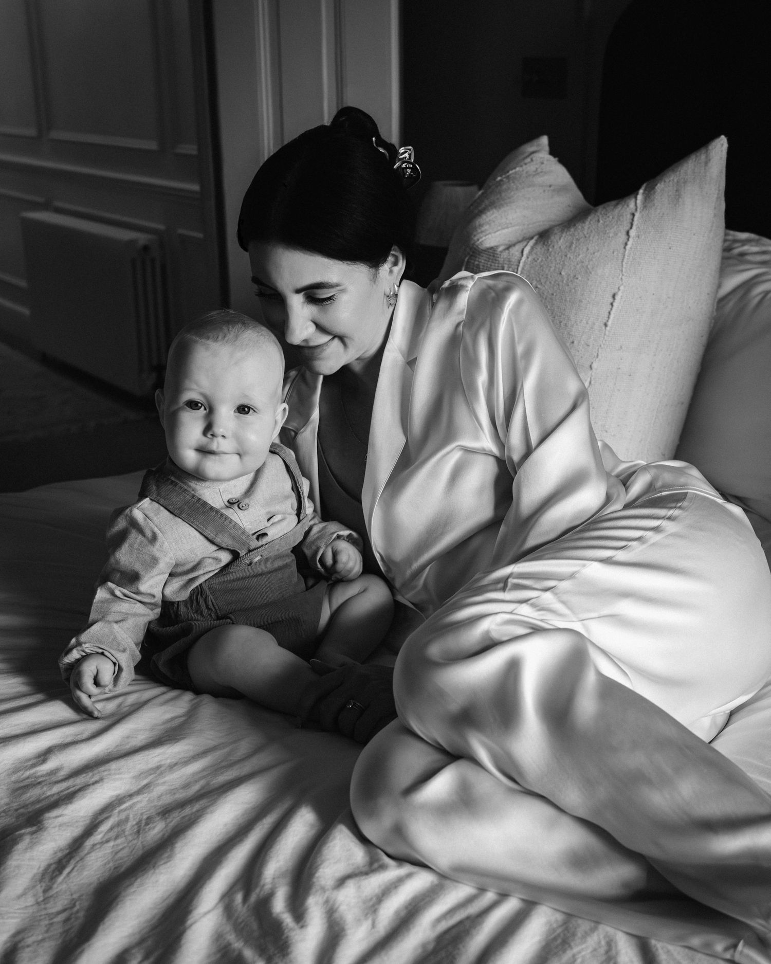 Intimate black and white photo sequence showing gentle interactions on bedding.