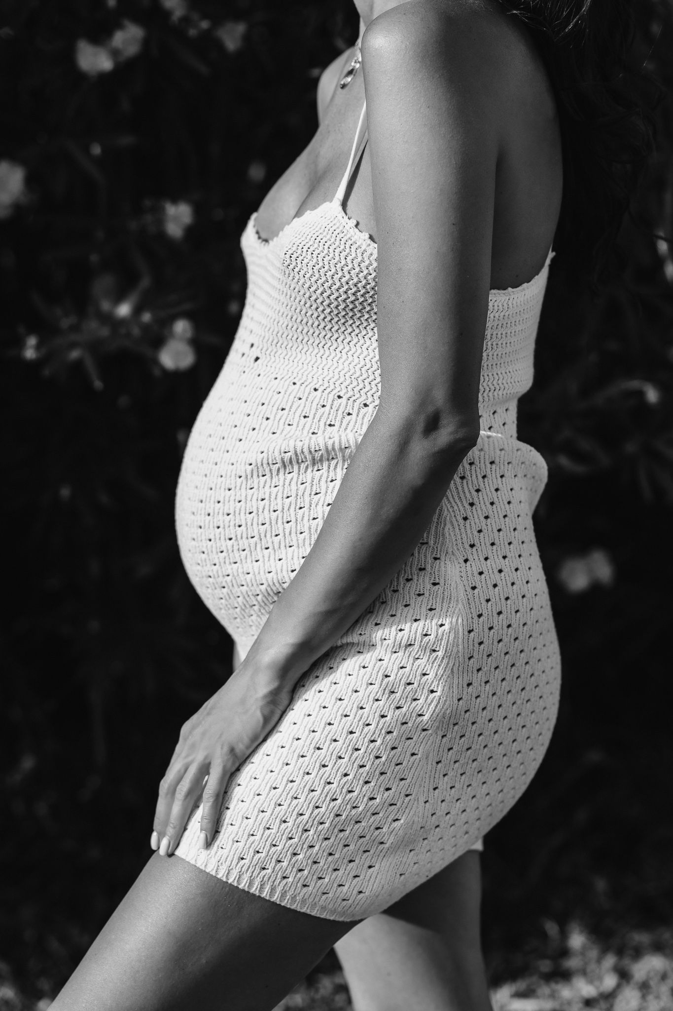 Artistic black and white photos of white crochet dress details.