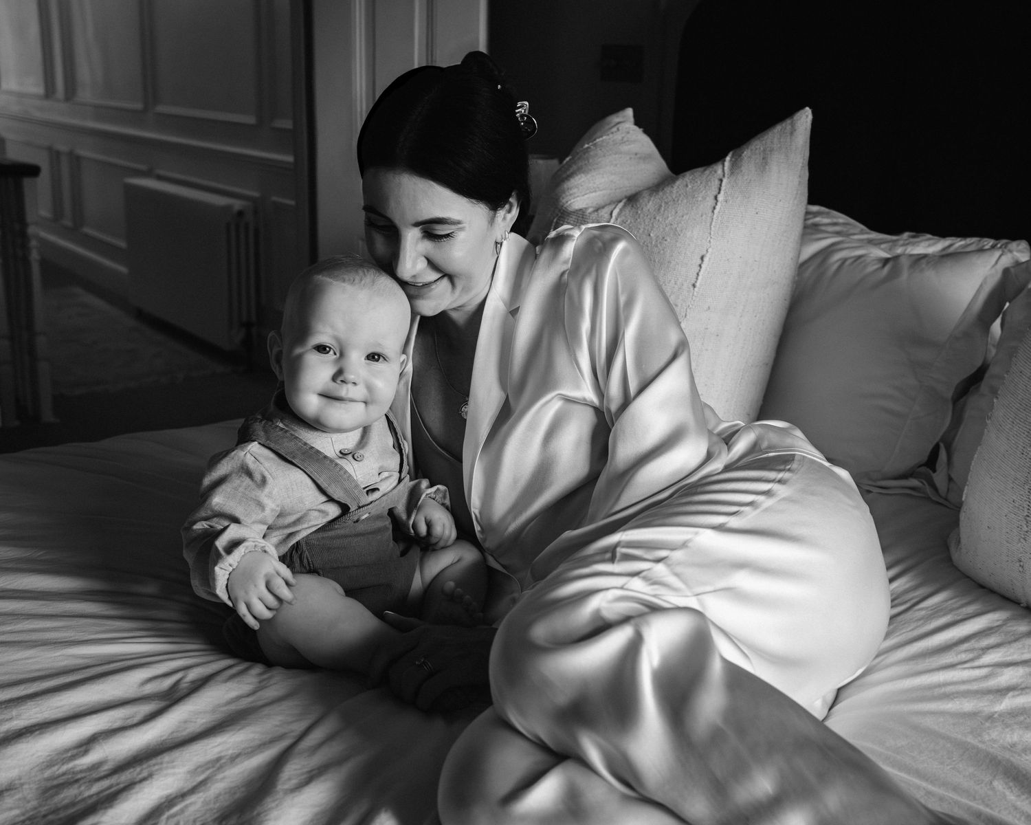 Black and white intimate sequence showing tender moments between parent and baby.