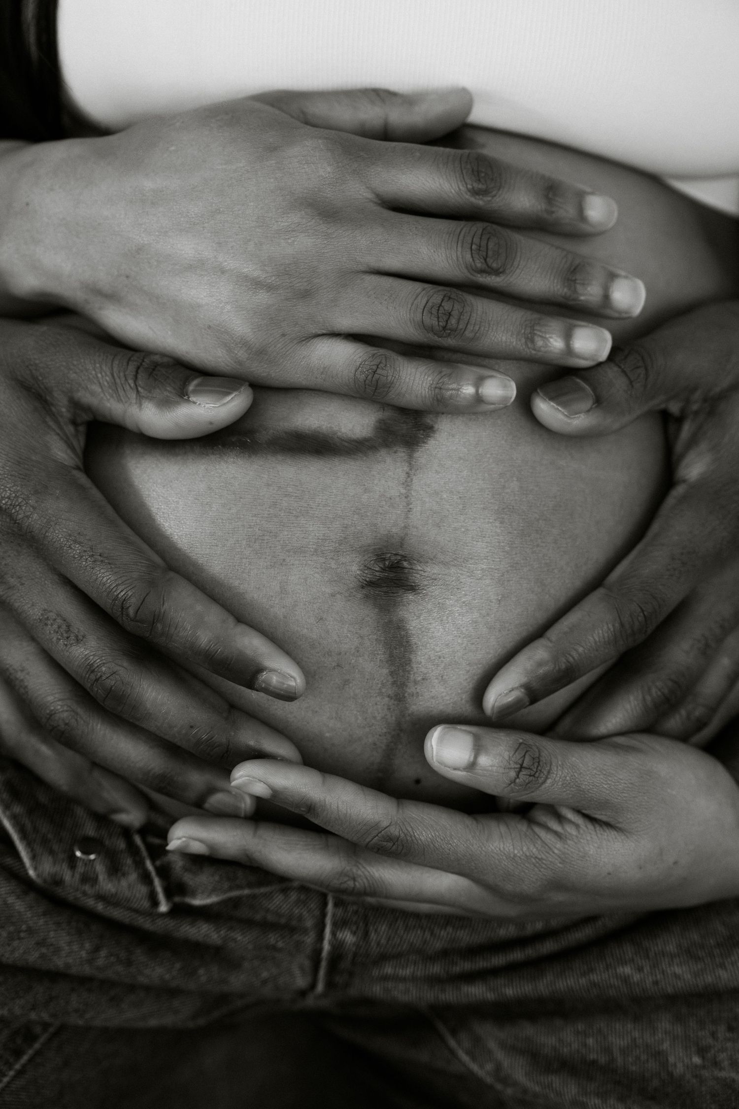Black & white intimate maternity portrait, couple's hands on baby bump showing linea nigra | London maternity photographer by Inga Franlund