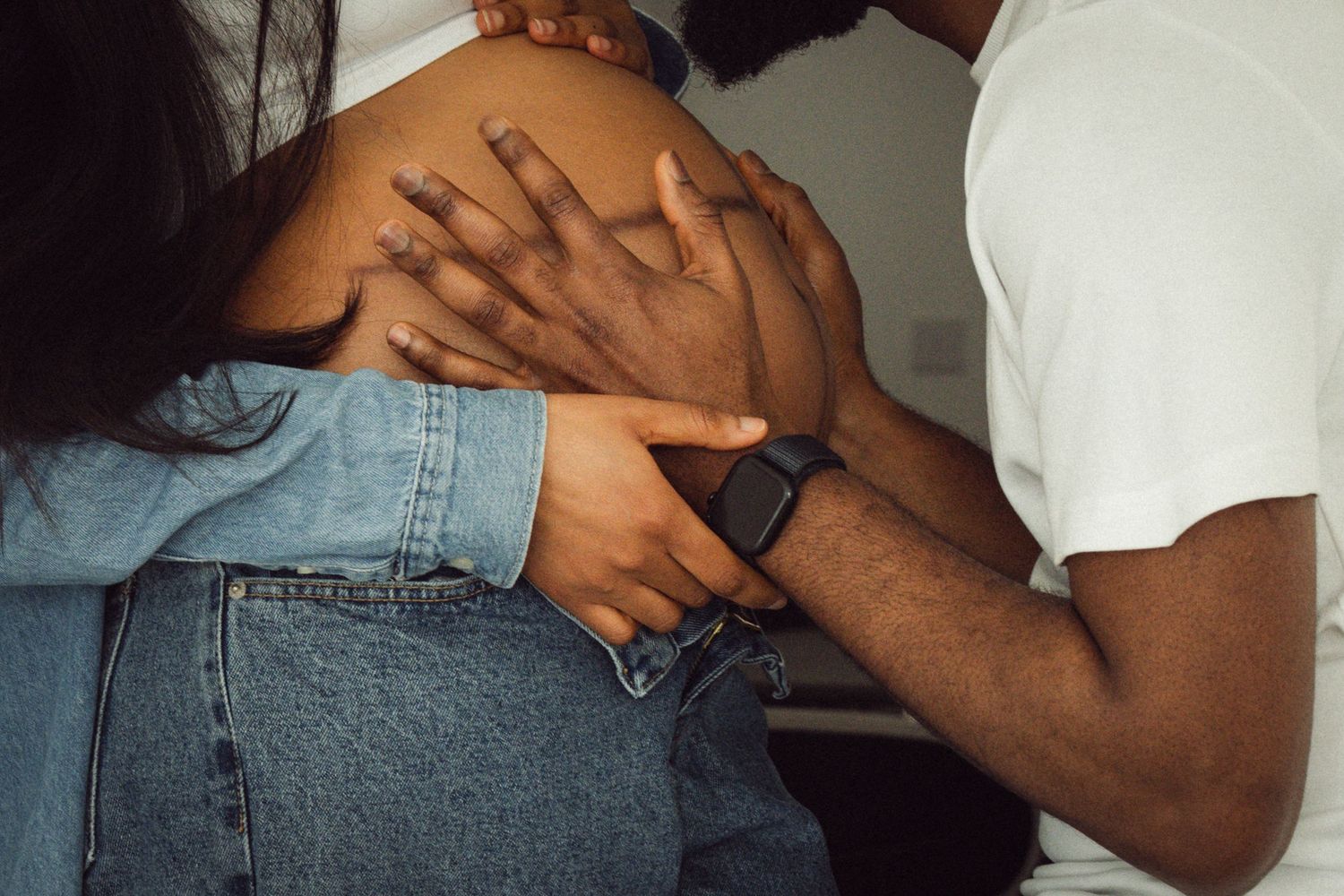 Intimate maternity portrait, couple embracing with hands on baby bump | London maternity photographer by Inga Franlund