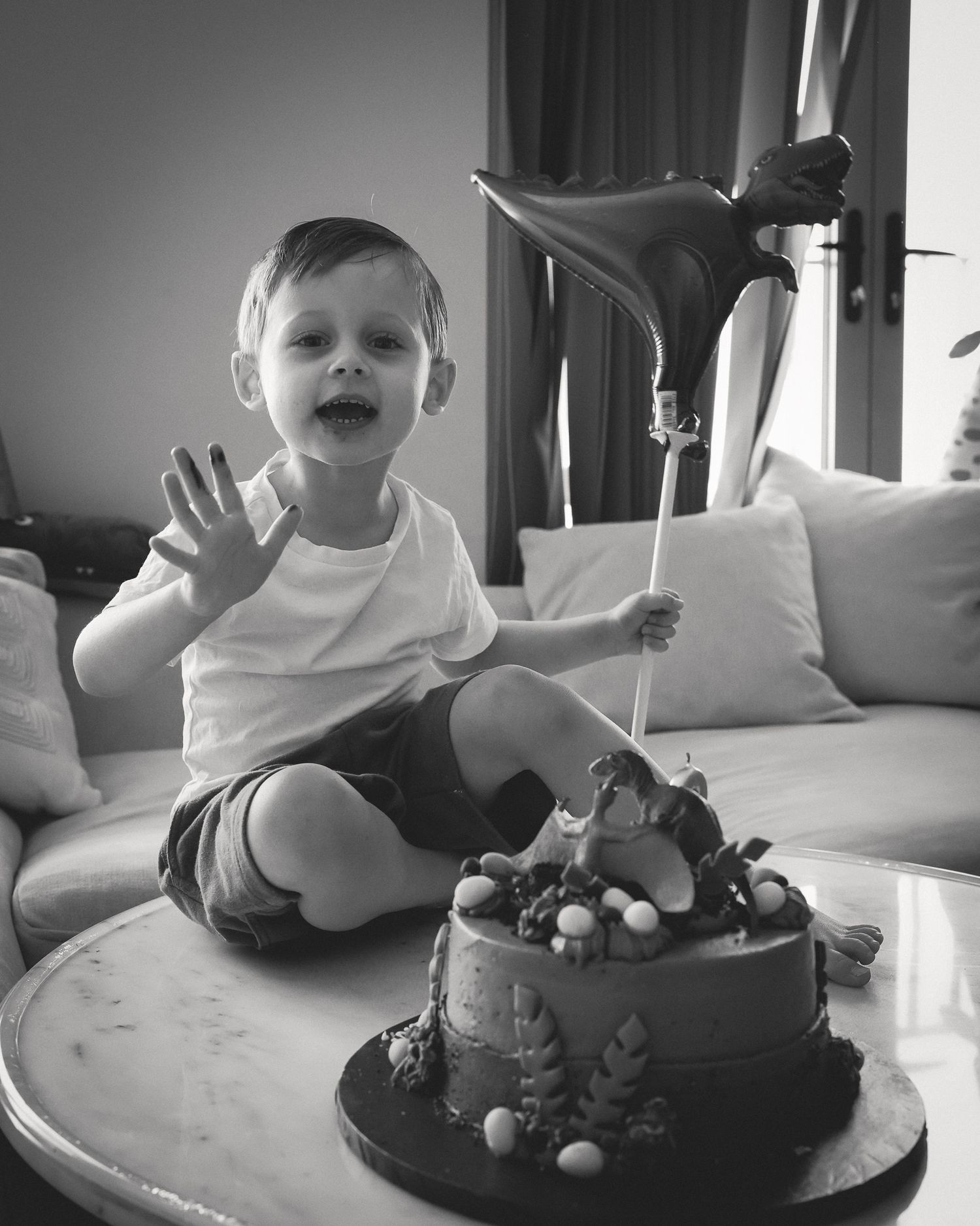 A sequence showing a young child's excitement while celebrating with a chocolate birthday cake.