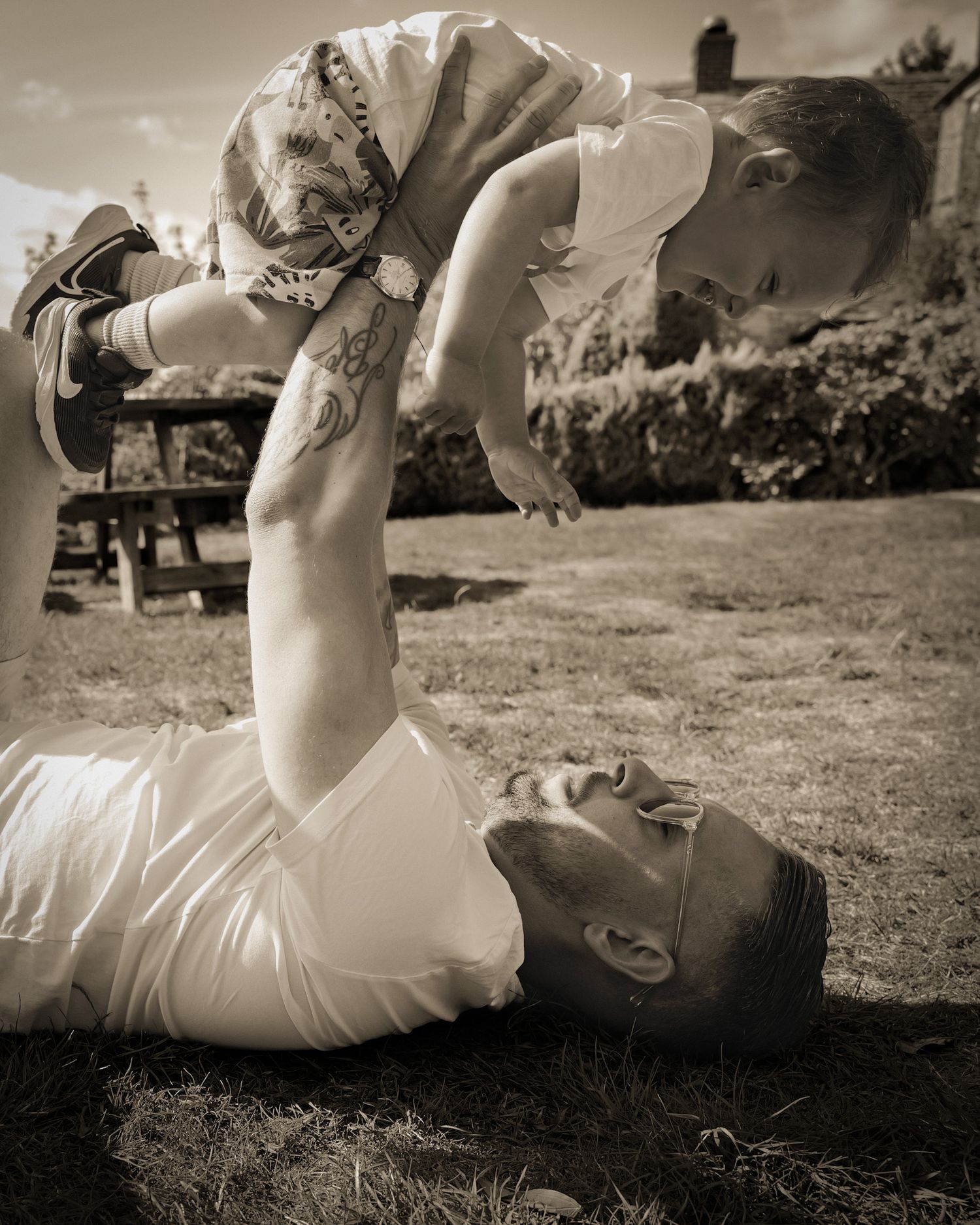 Black and white photo series of person lying in grass outdoors.