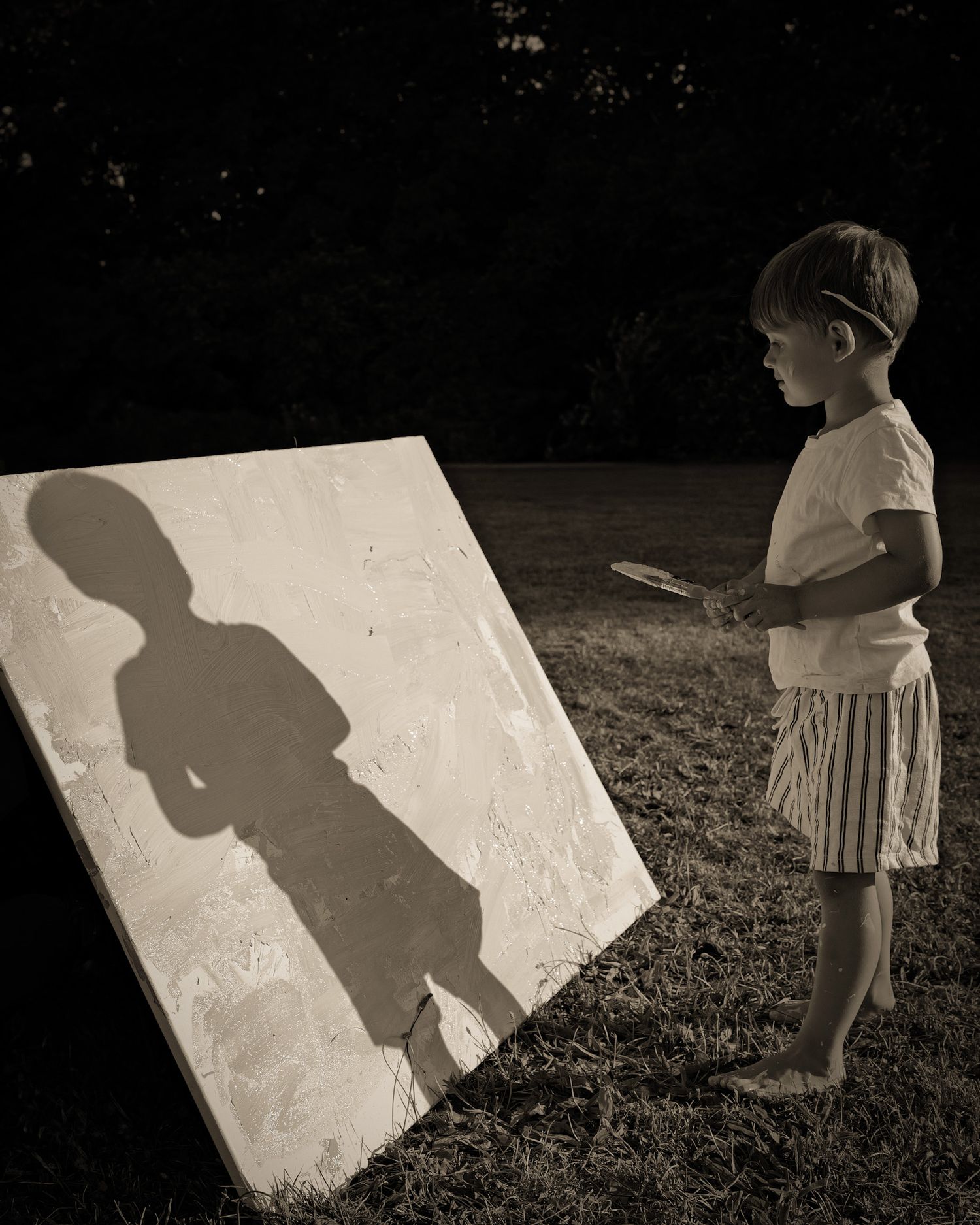 Black and white sequence showing shadows cast on a white board outdoors.