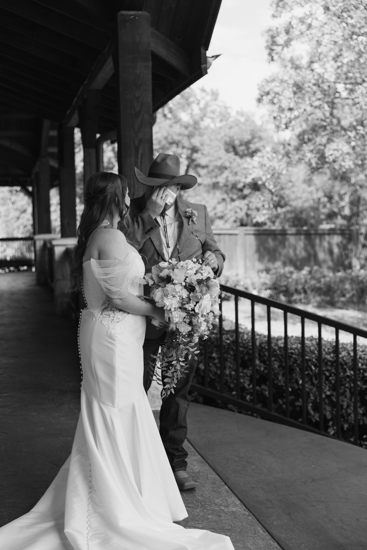 A black and white photo series of a couple in wedding attire embracing on a covered porch.