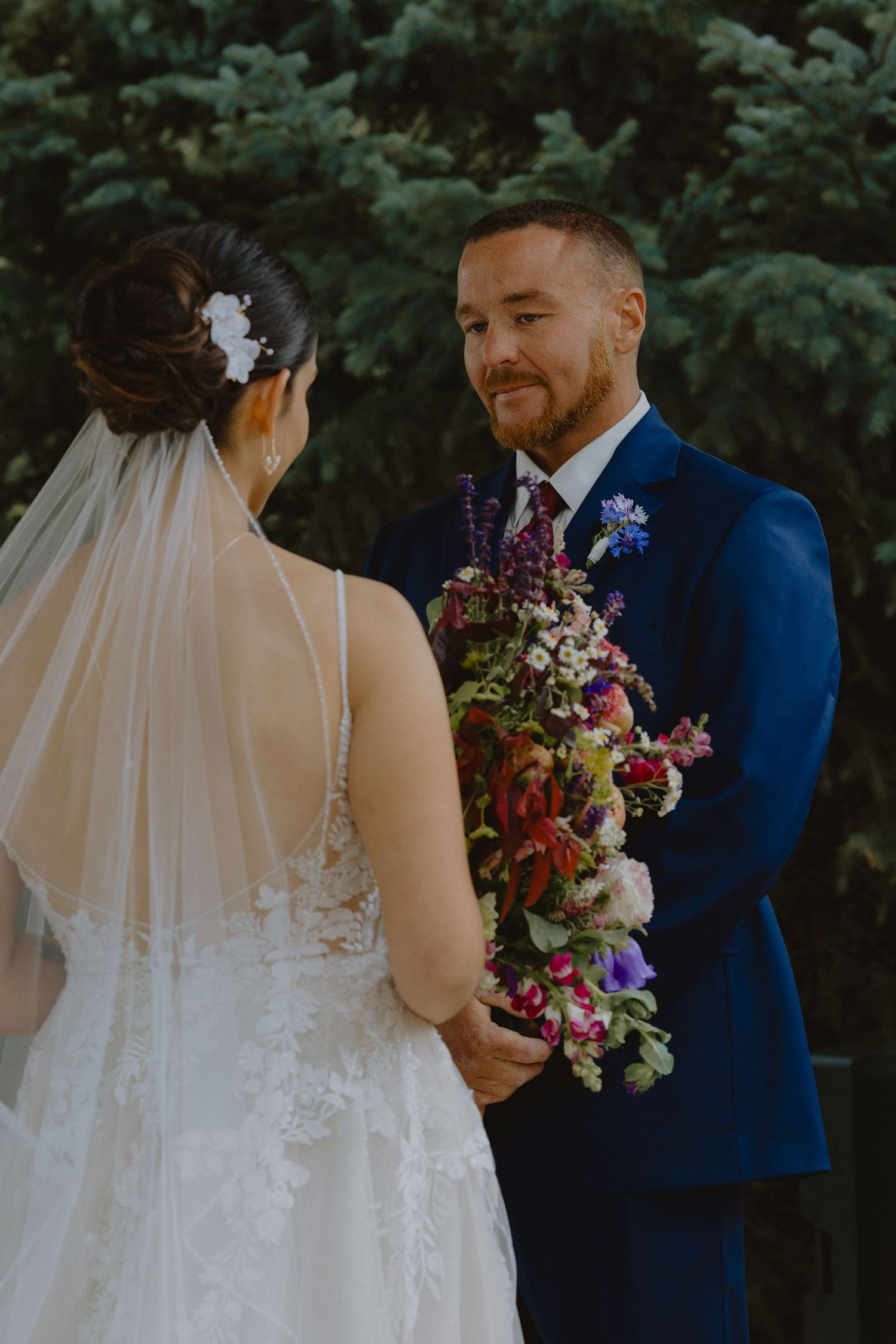 groom crying while seeing bride on wedding day, during wedding ceremony