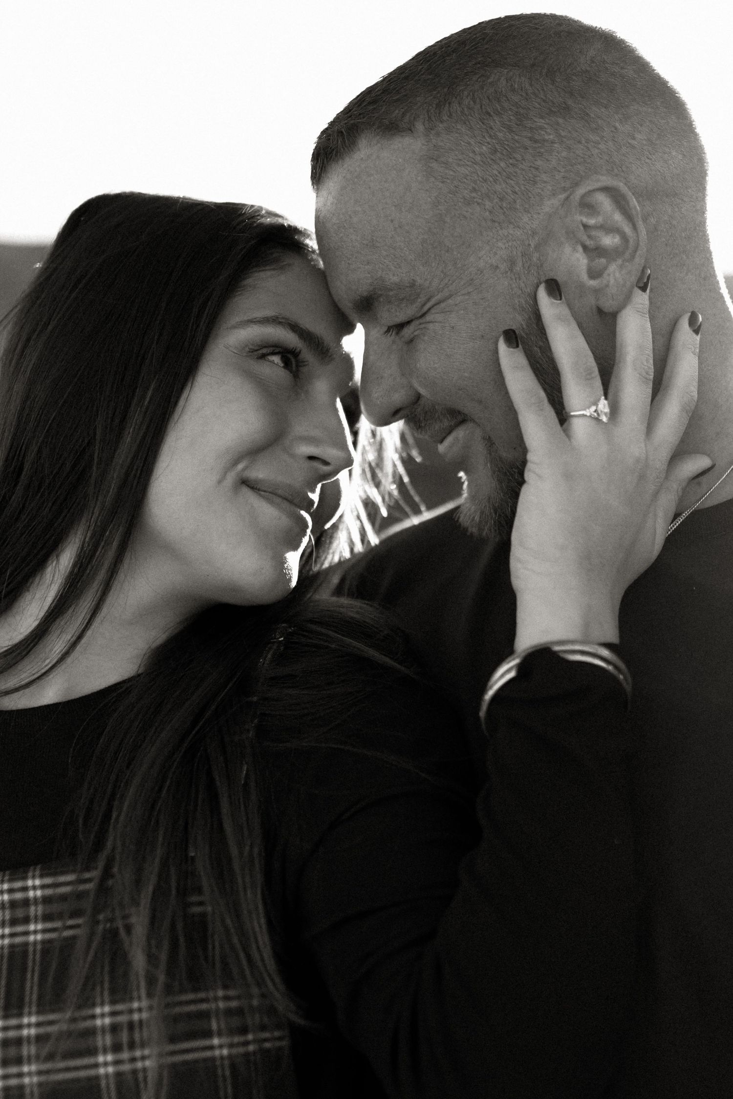 couple engagement photo in black and white, grand junction colorado on colorado national monument, couple is smiling close up