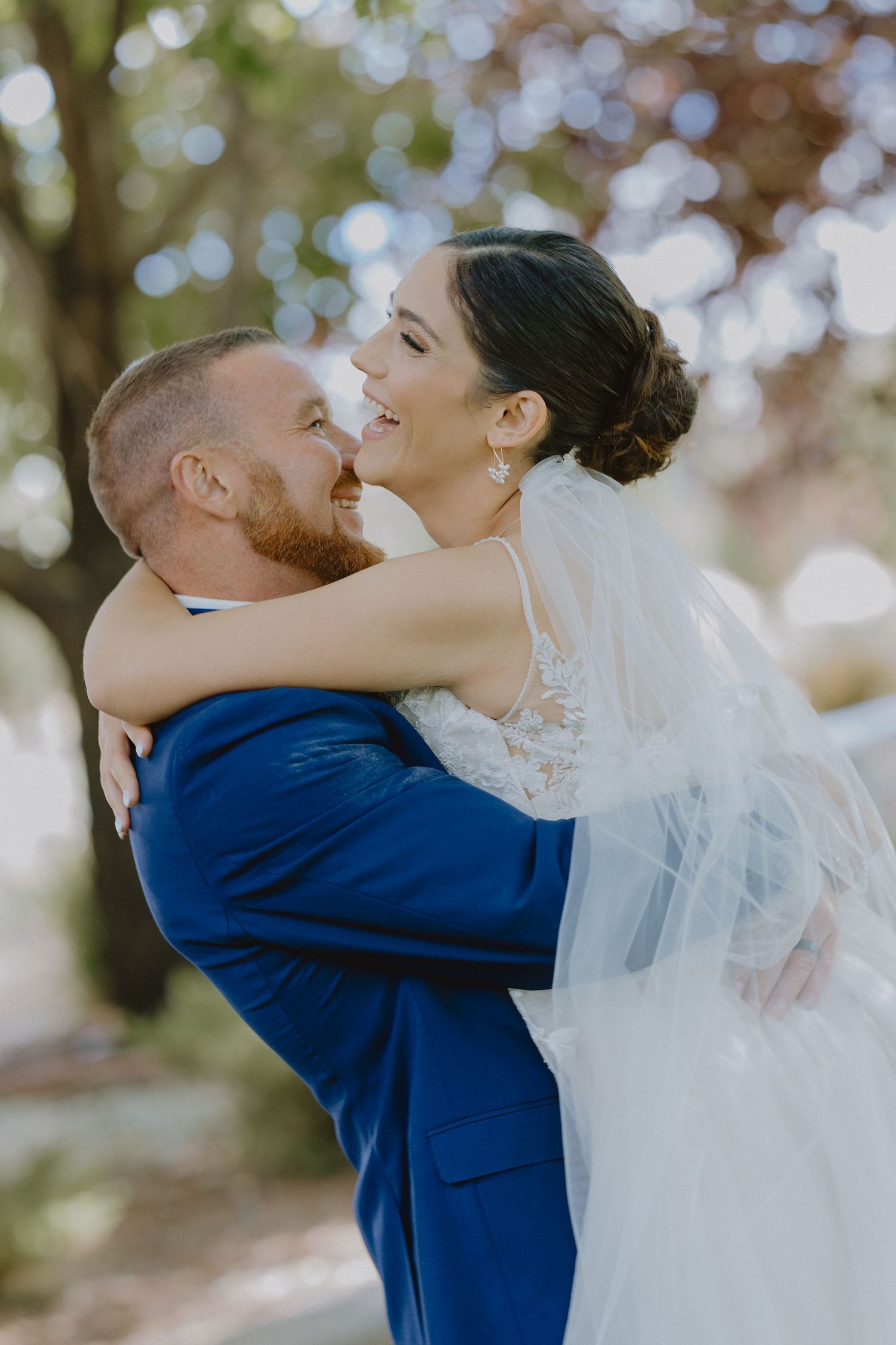 Bride and groom embrace on their wedding day in Delta, CO. A candid, romantic moment captured by a Western Colorado wedding photographer.