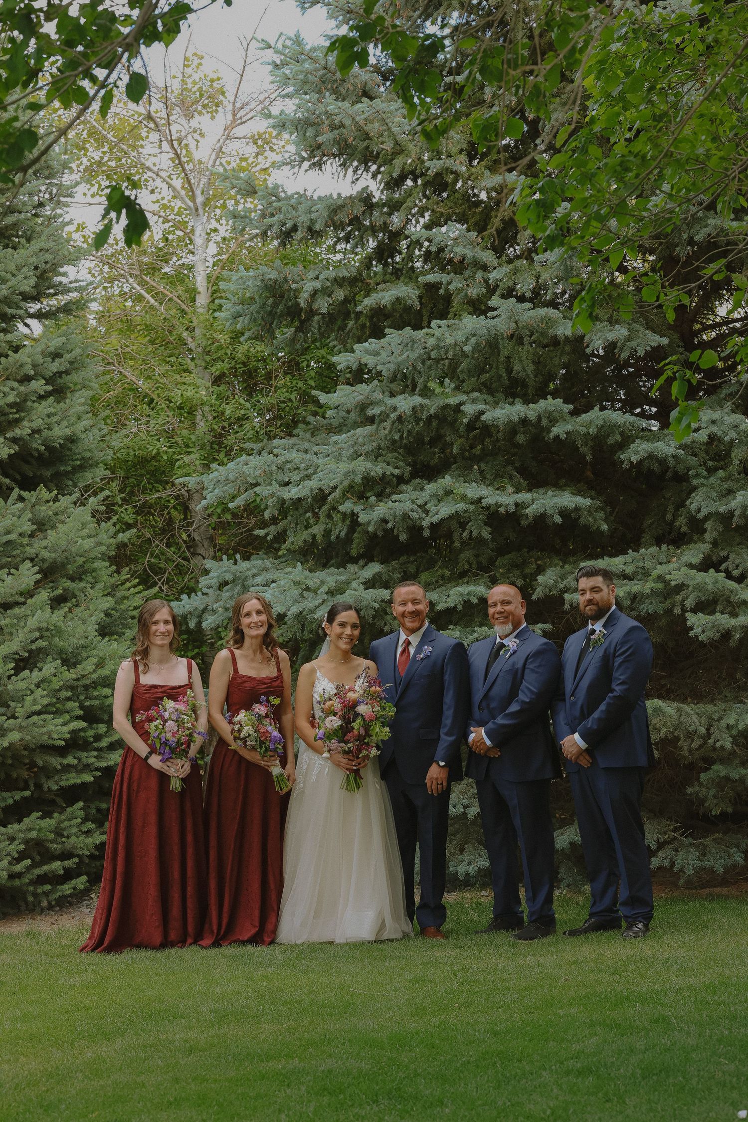 bride and groom photo, everyone smiling in pine tree background outdoor ceremony