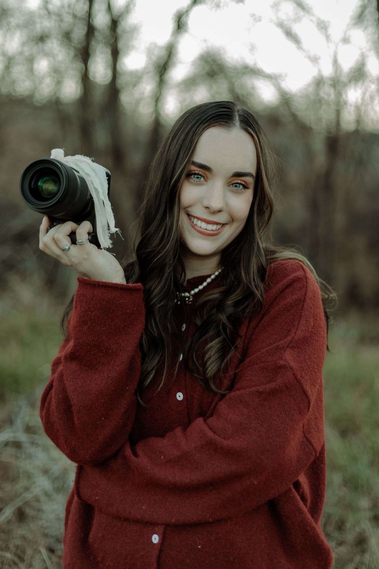 girl smiling  with camera, she is a western colorado photographer offering services.
