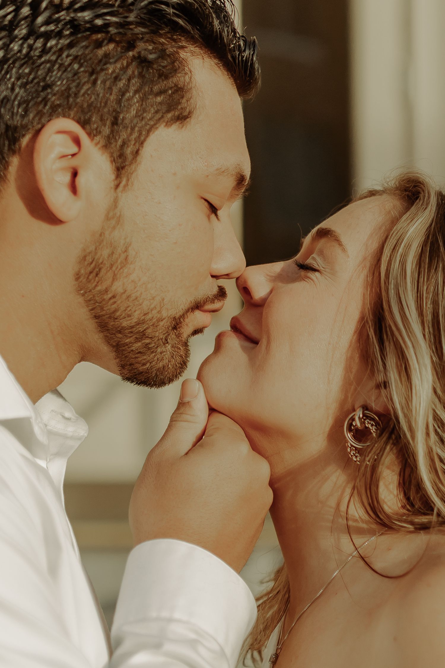 couple engagement photography in grand junction colorado, man pulling girl into a kiss by her chin