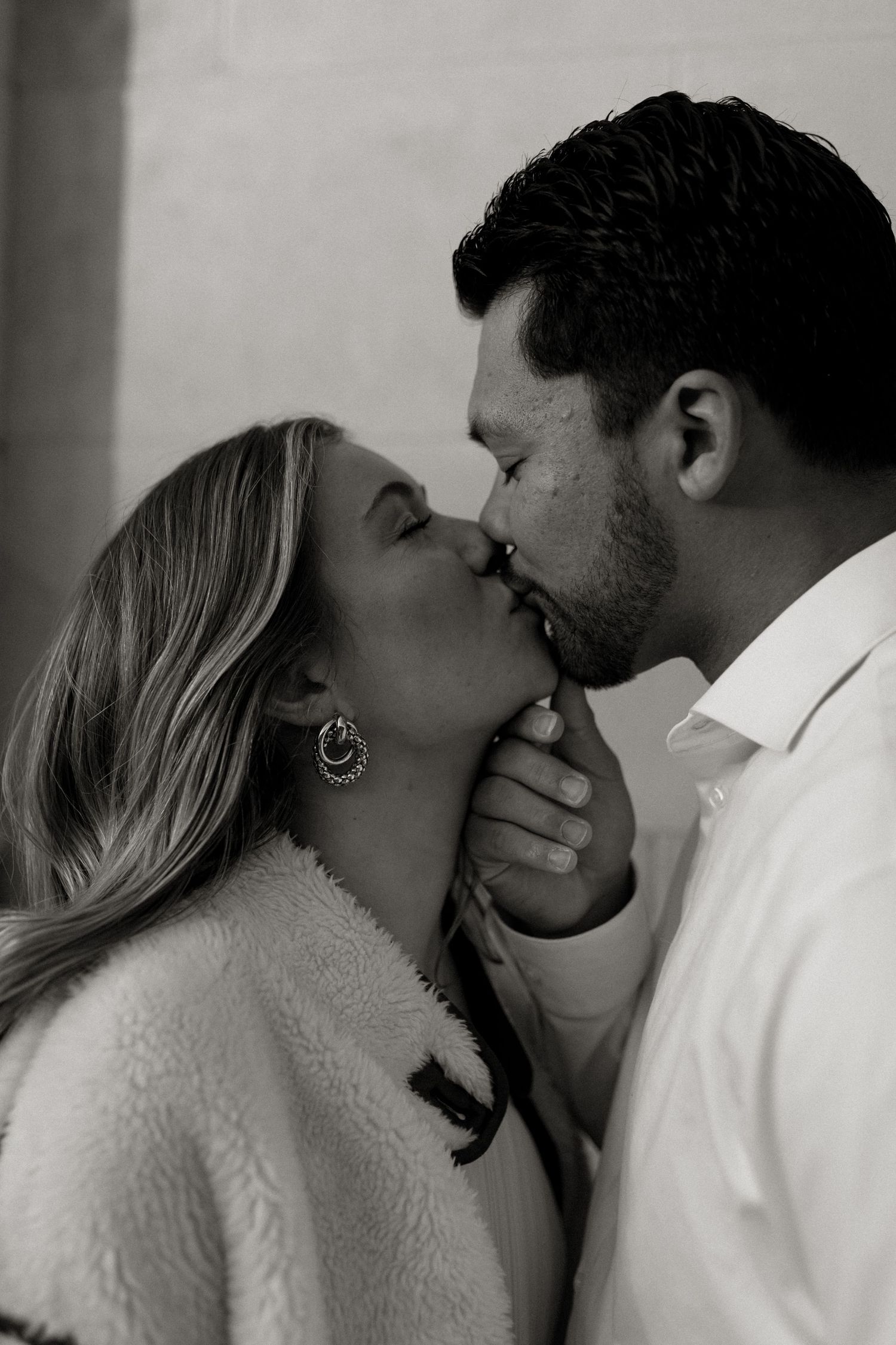 black and white photoshoot in downtown grand junction of couple kissing during engagement session