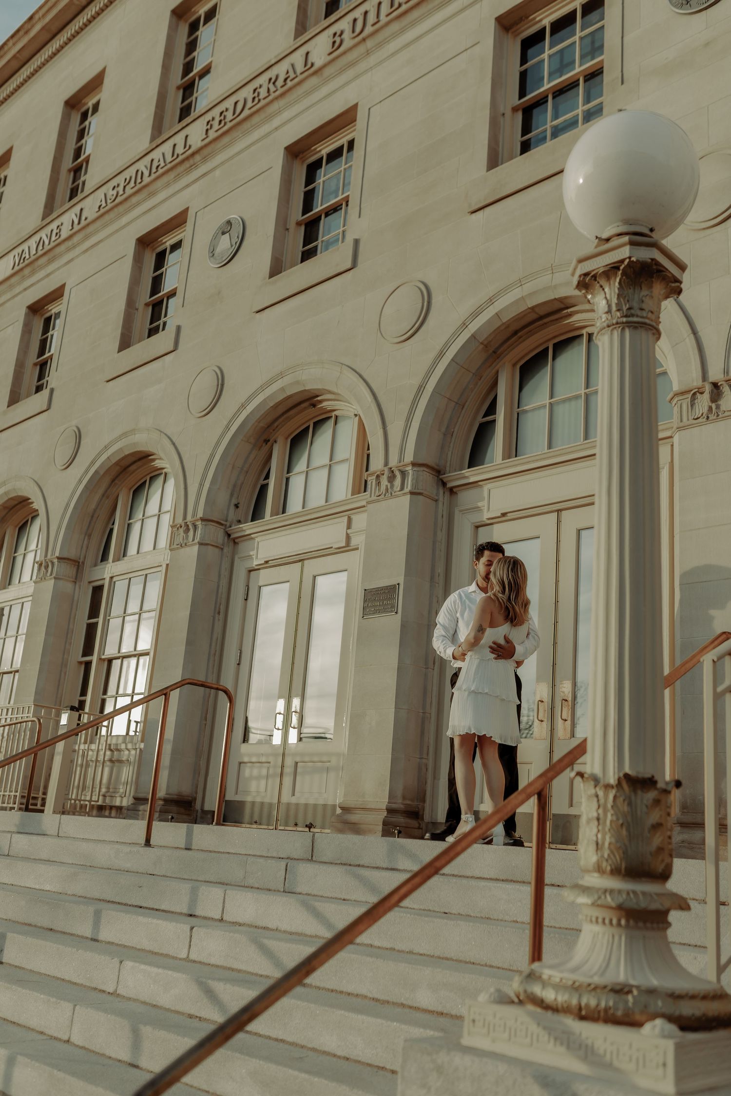 grand junction colorado city courthouse photo of  couple posing in front of the building, classy and elegant engagement session